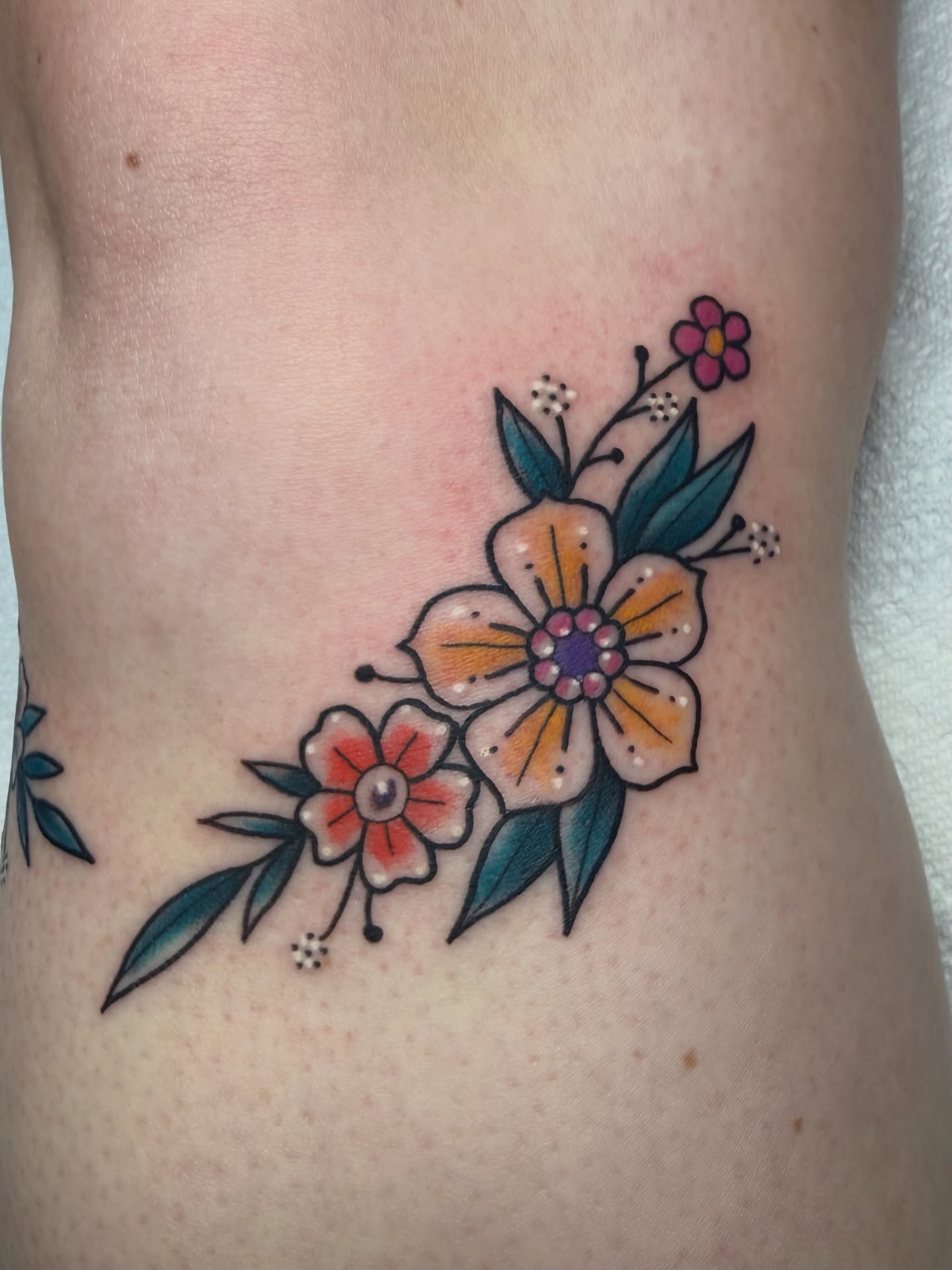 Floral arrangement dotwork tattoo on the ribs by Ashley Laine Evans