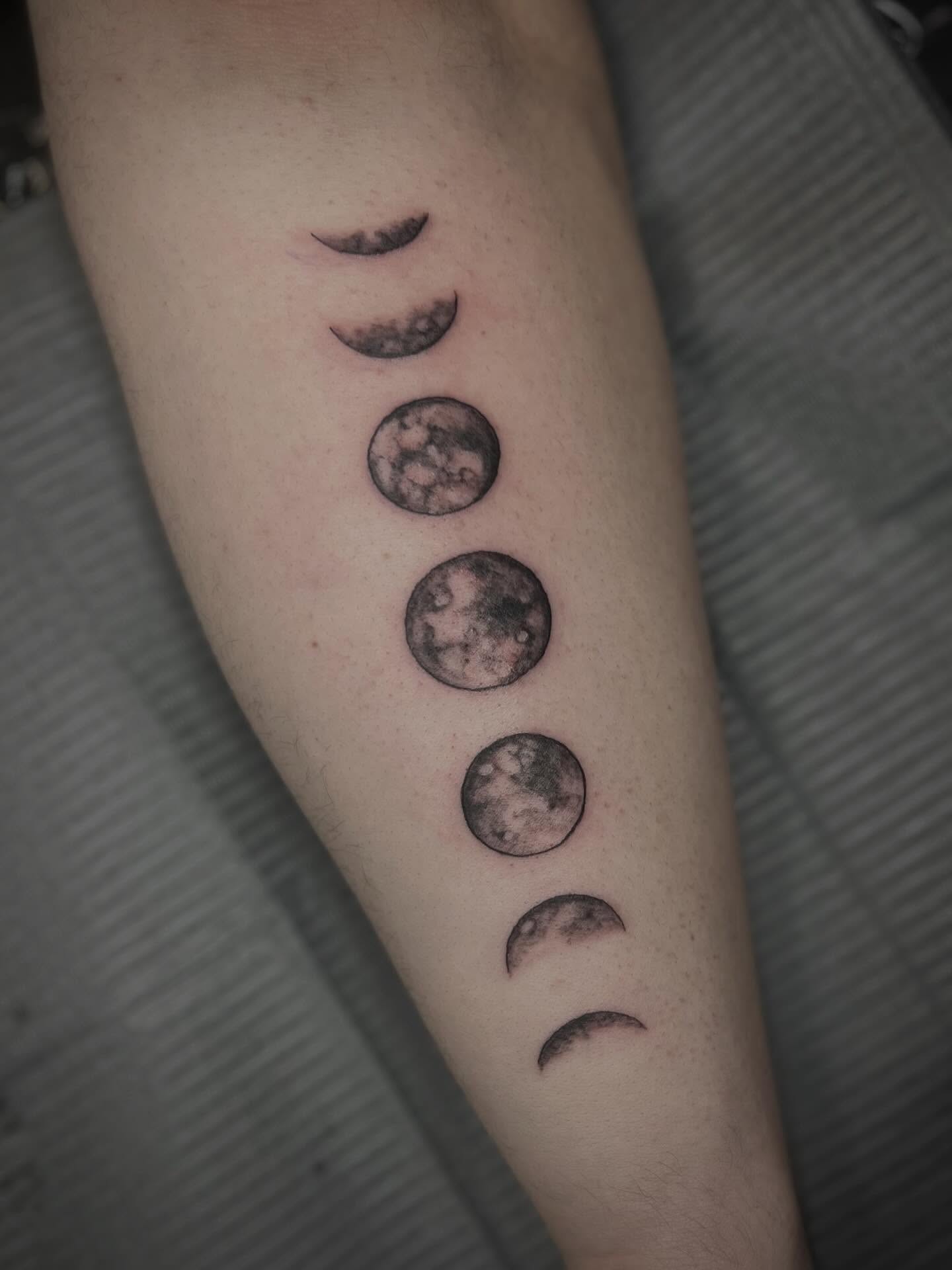 Moon phases black and grey tattoo on the forearm by Lexi Rose