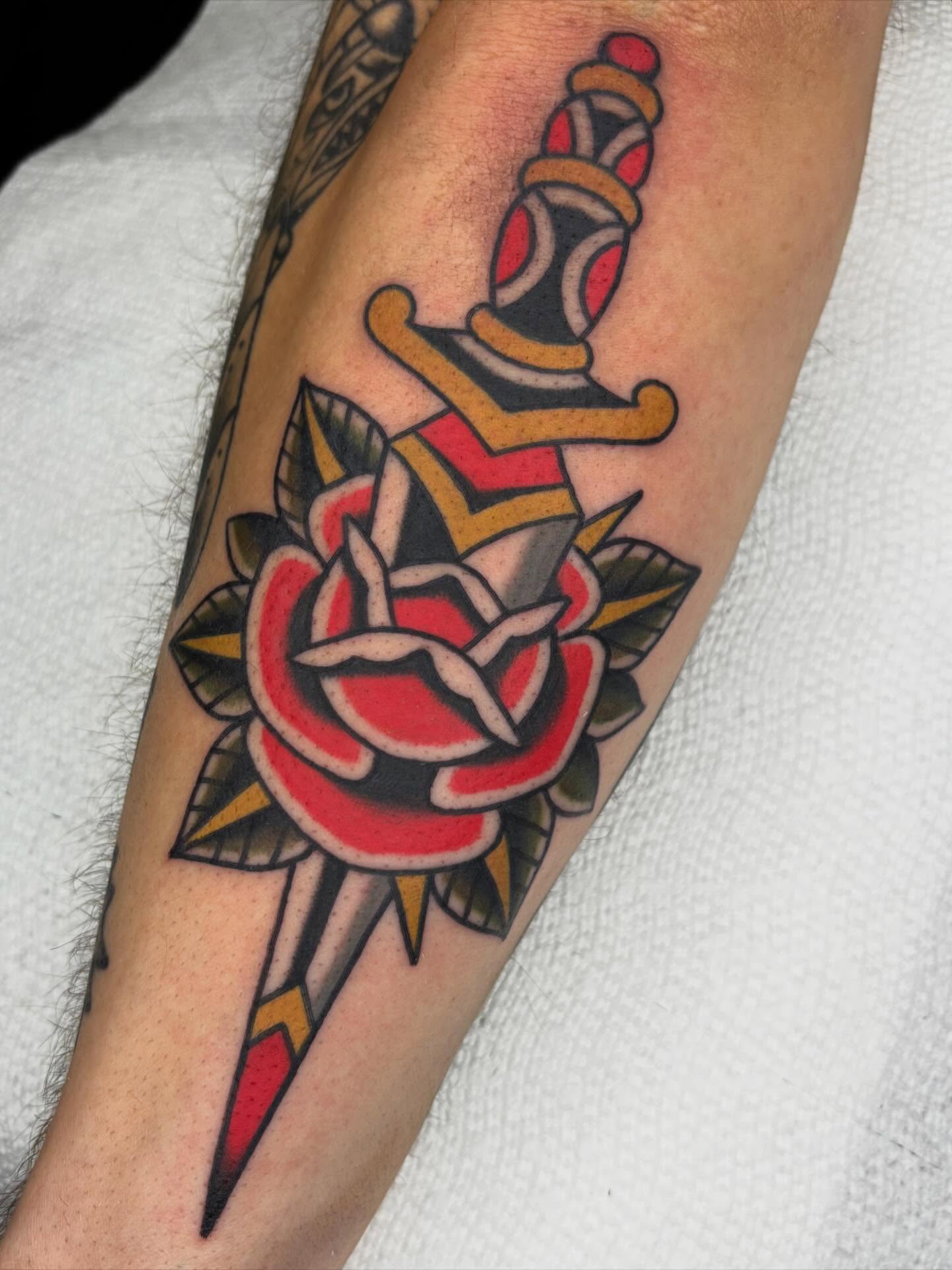 Rose and dagger American traditional tattoo on the forearm by Arturo Ledesma