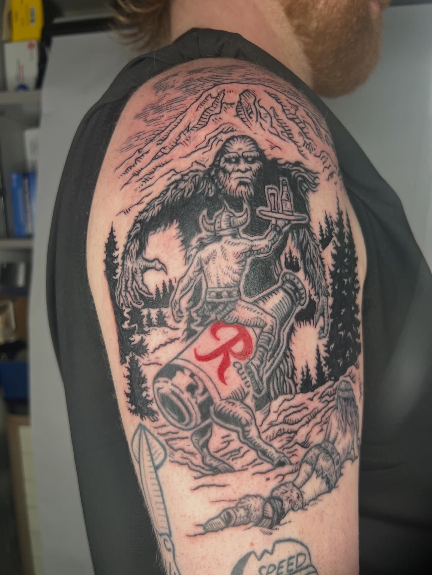 Bigfoot carrying tray realism tattoo on the shoulder by Jason Middelton