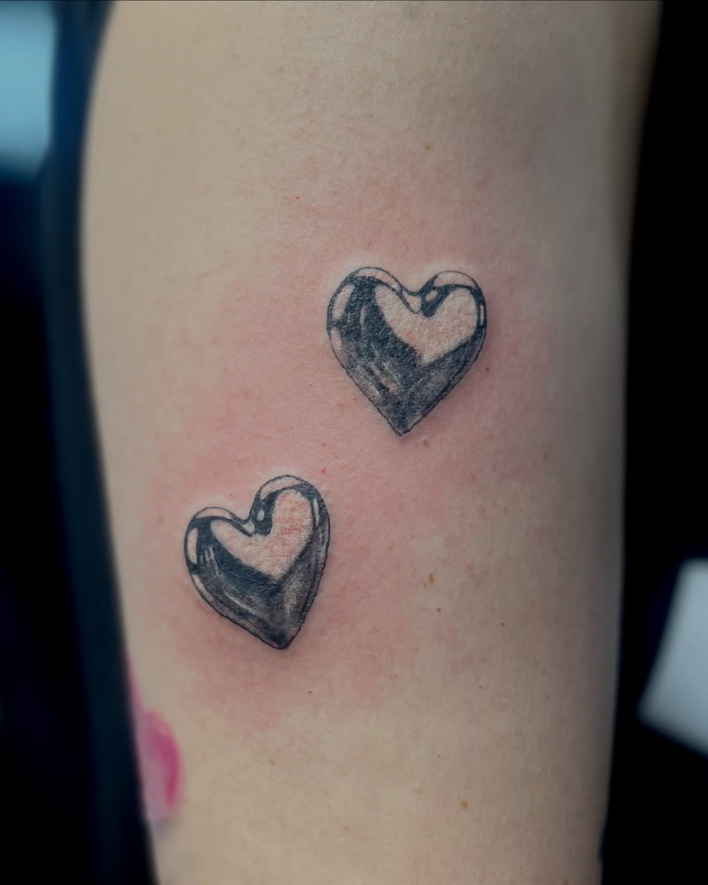 Hearts black and grey tattoo on the forearm by EO, Chicago, Illinois