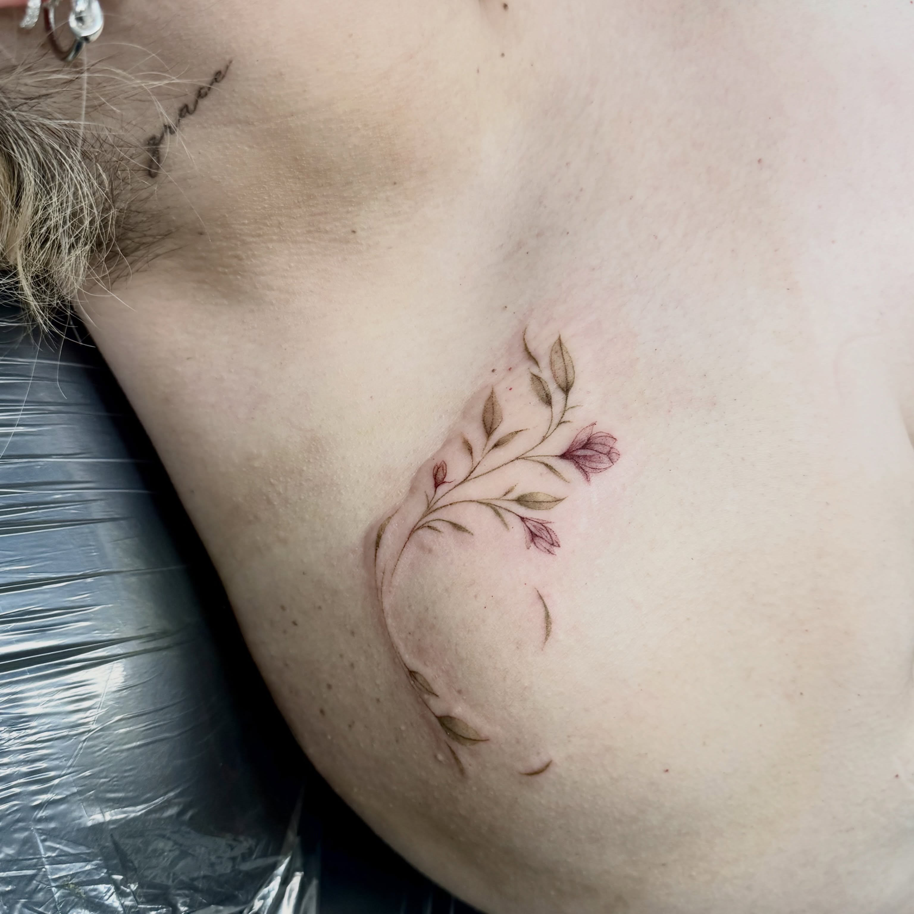 Floral branch dotwork tattoo on the chest by Ava De La Torre