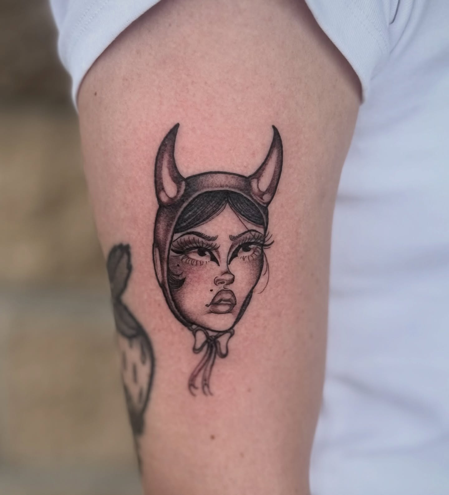 Woman wearing horns black and grey tattoo on the forearm by K9