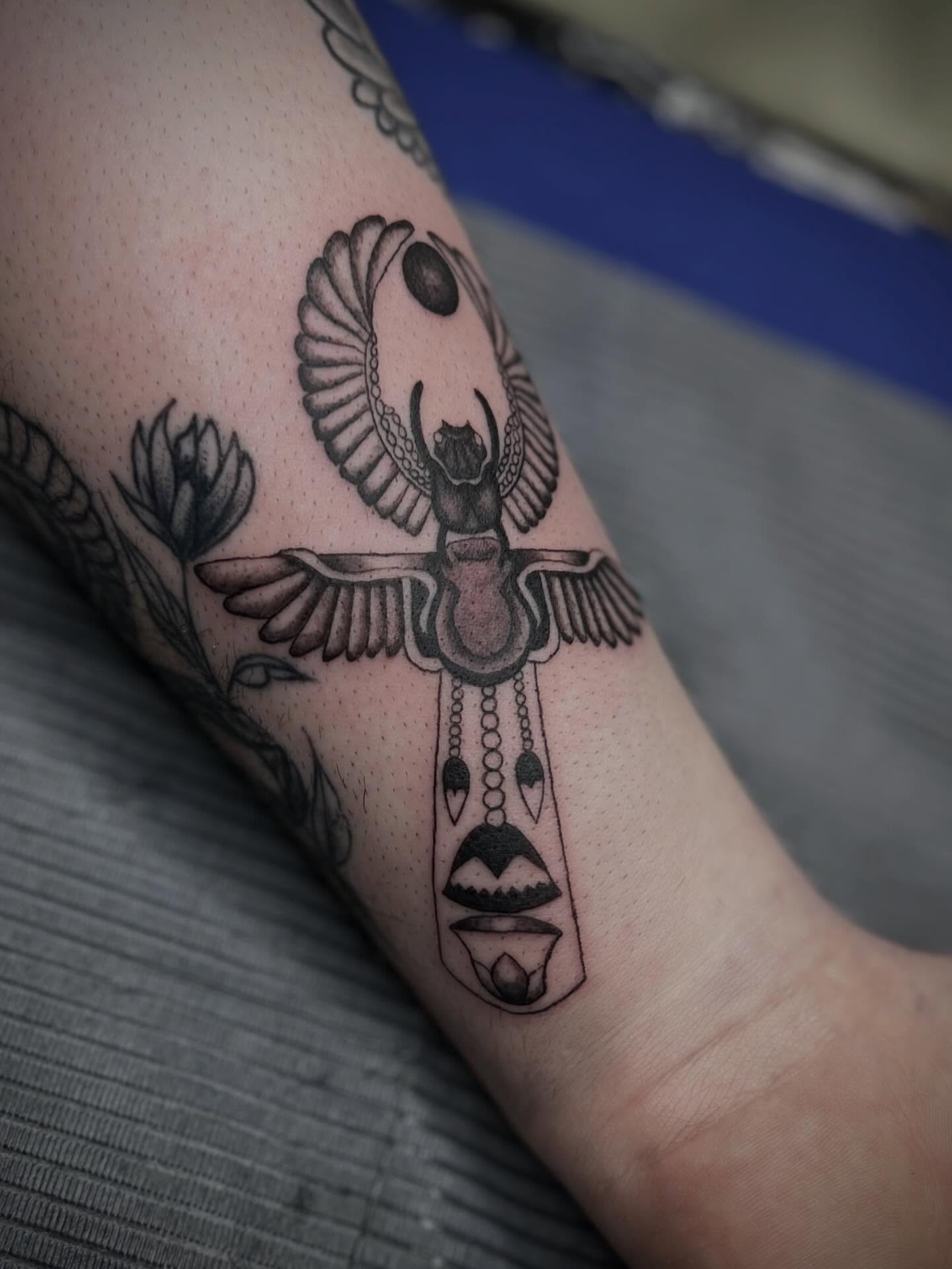 Scarab beetle black and grey tattoo on the forearm by Lexi Rose