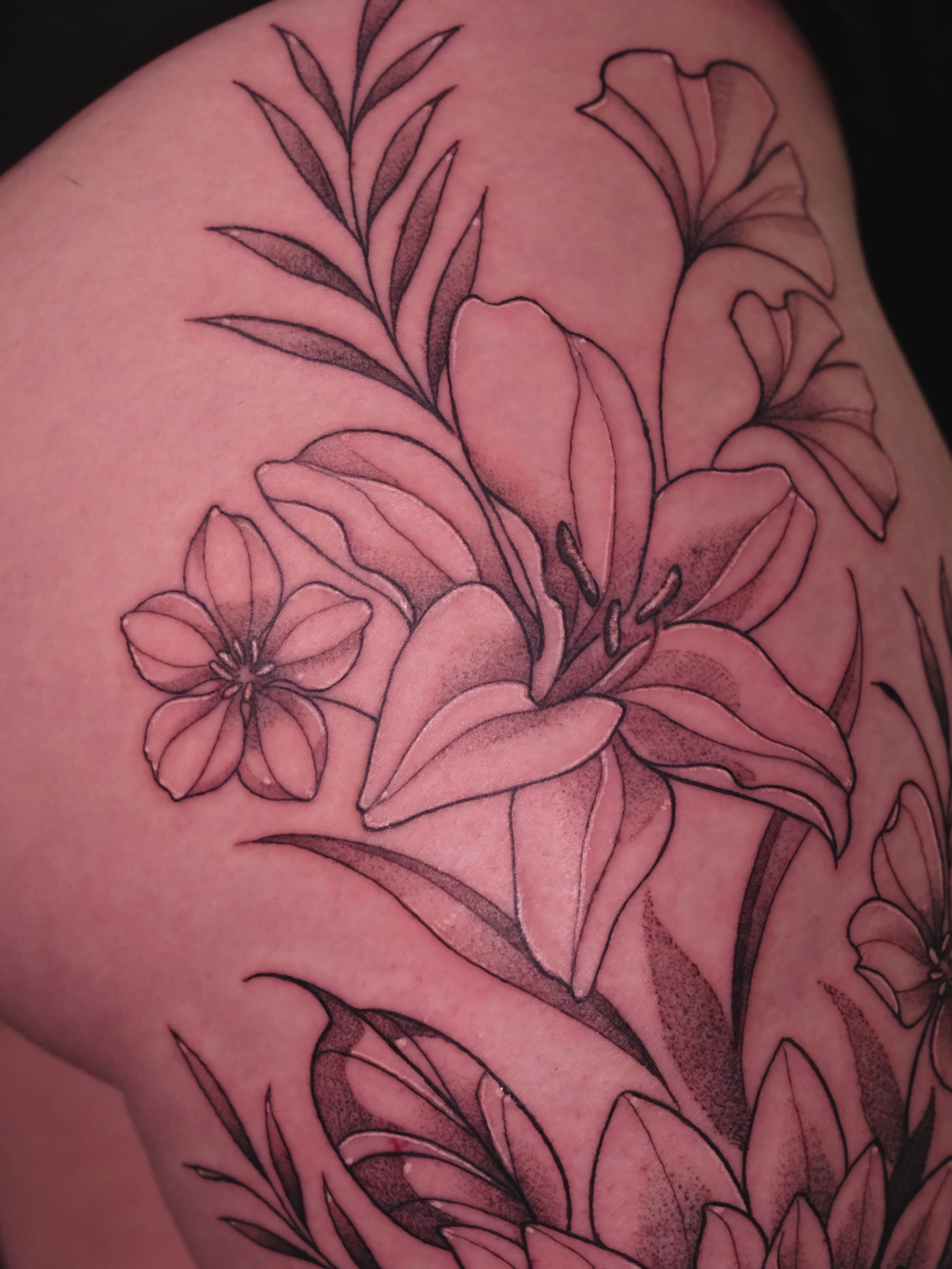 Lilies black and grey tattoo on the shoulder by Velvet, Seattle, Washington