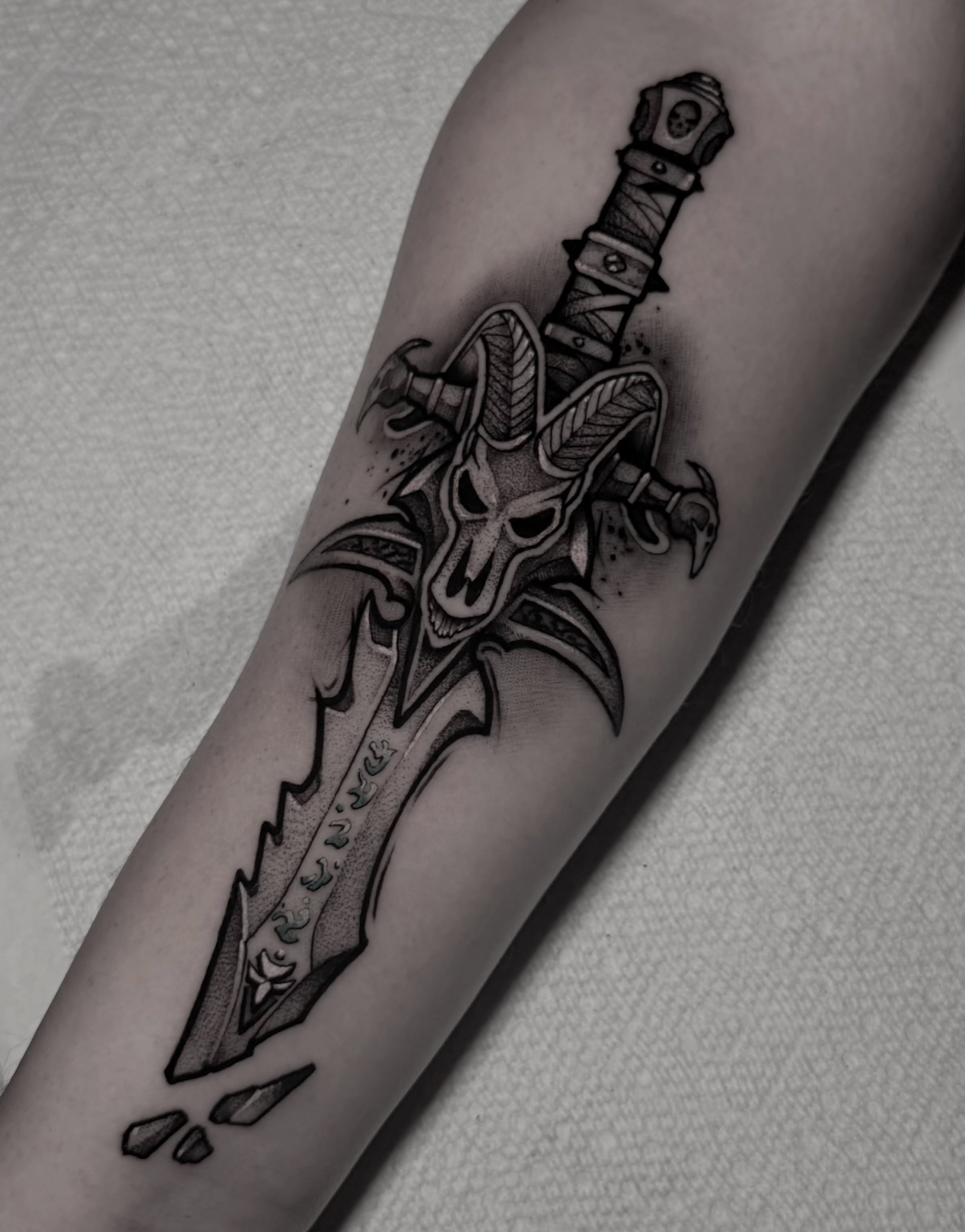 Demon skull sword dark realism tattoo on the forearm by Clayton Smith (BEAR)