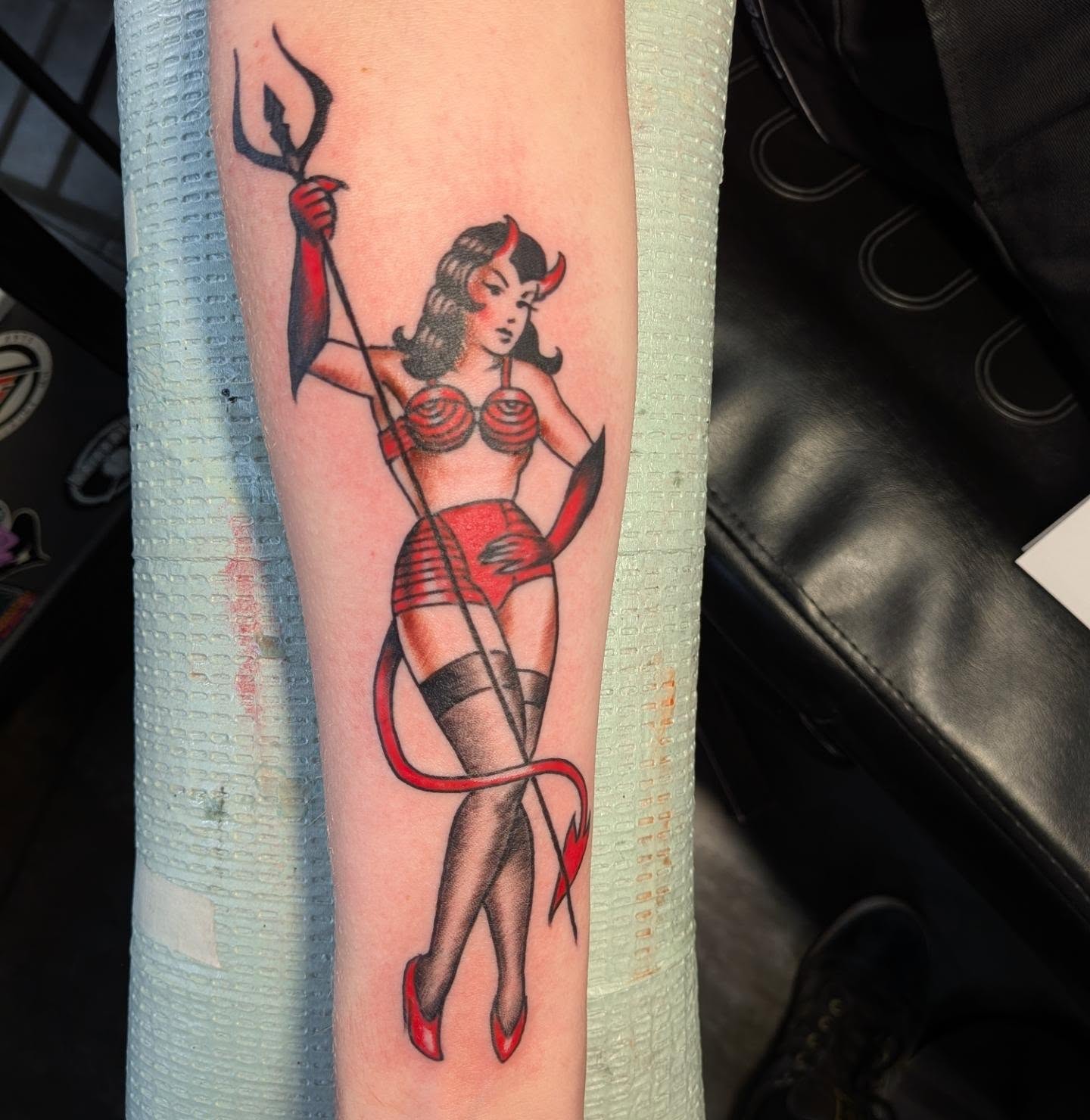 Devil pin-up girl American traditional tattoo on the forearm by Nic Skrade, Minneapolis, Minnesota