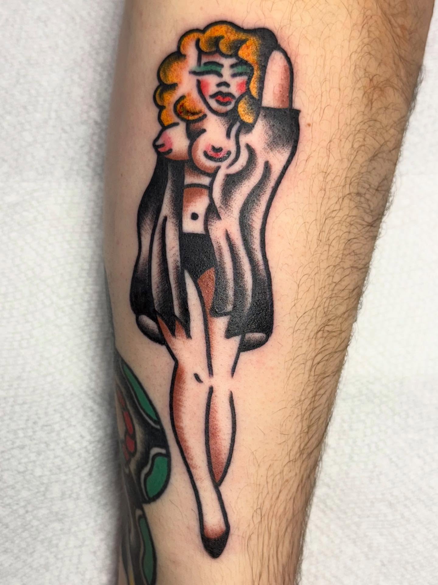 Female figure American traditional tattoo on the forearm by Jesse Coldiron