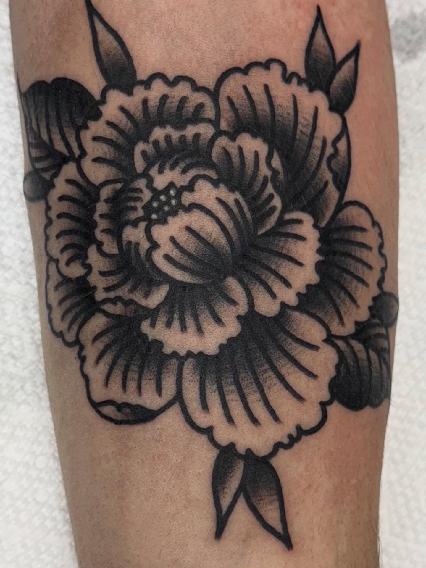 Peony black and grey tattoo on the forearm by Jesse Coldiron