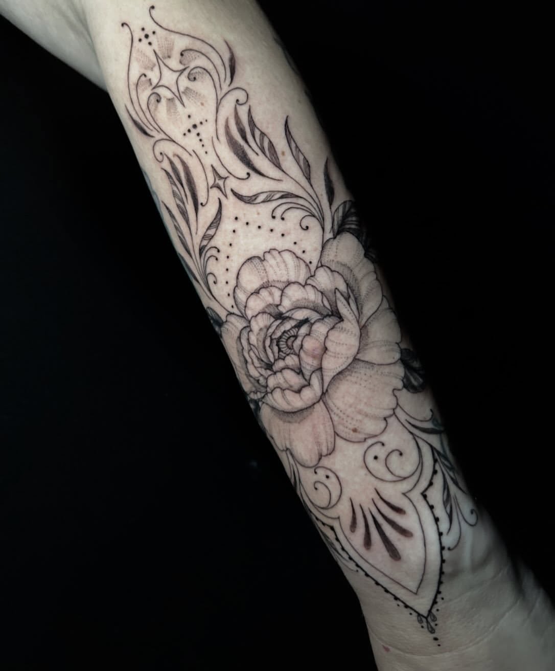 Peony black and grey tattoo on the forearm by Ashlee Mshar
