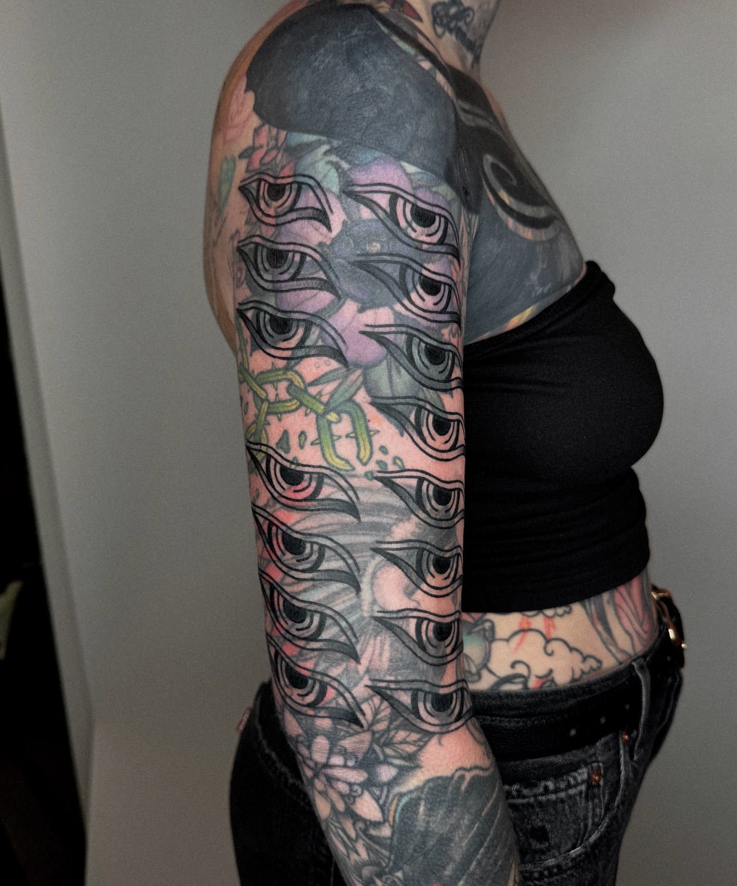 Eyes geometric tattoo on the upper arm by nicky joe