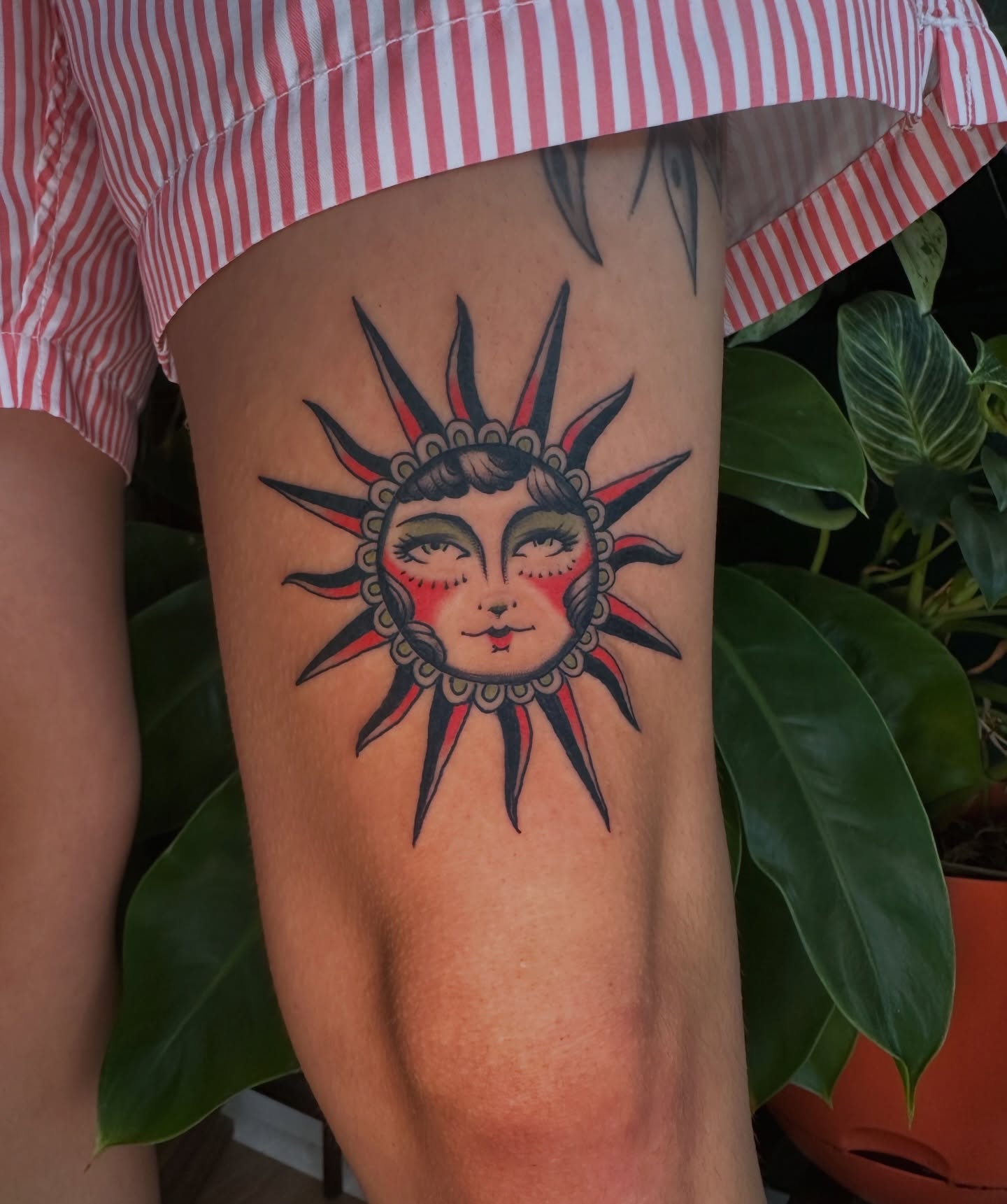 Sun face American traditional tattoo on the thigh by Max Peterson