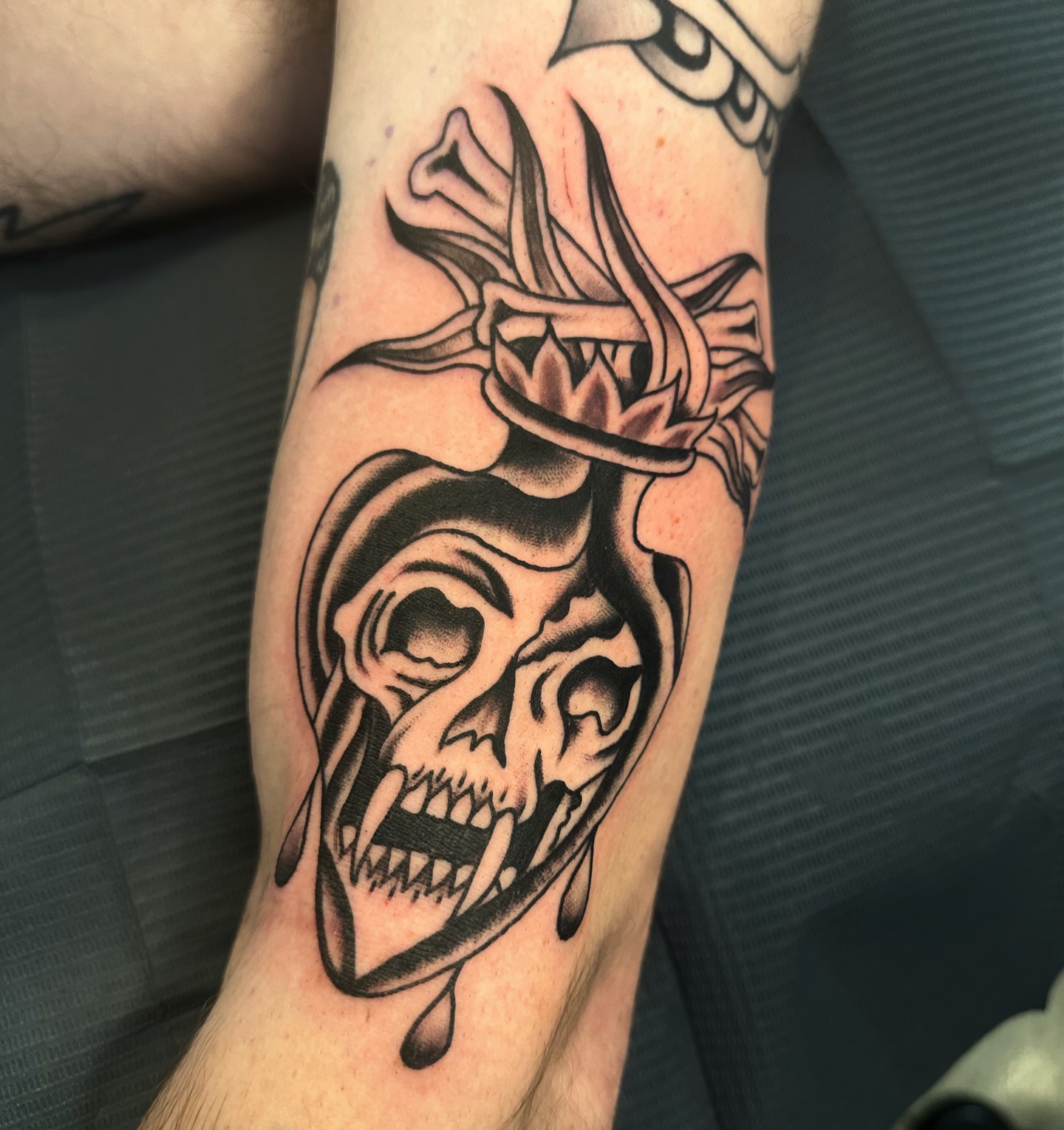 Grinning skull black and grey tattoo on the forearm by A.j. Lingerfeldt, Nashville, Tennessee