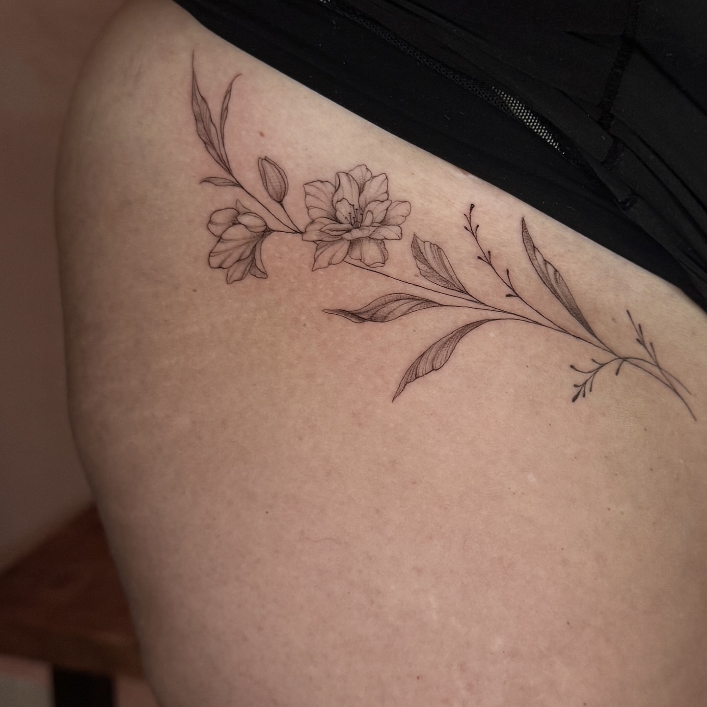 Flower branch black and grey tattoo on the shoulder by fine line tattoo artist▪️Austin TX