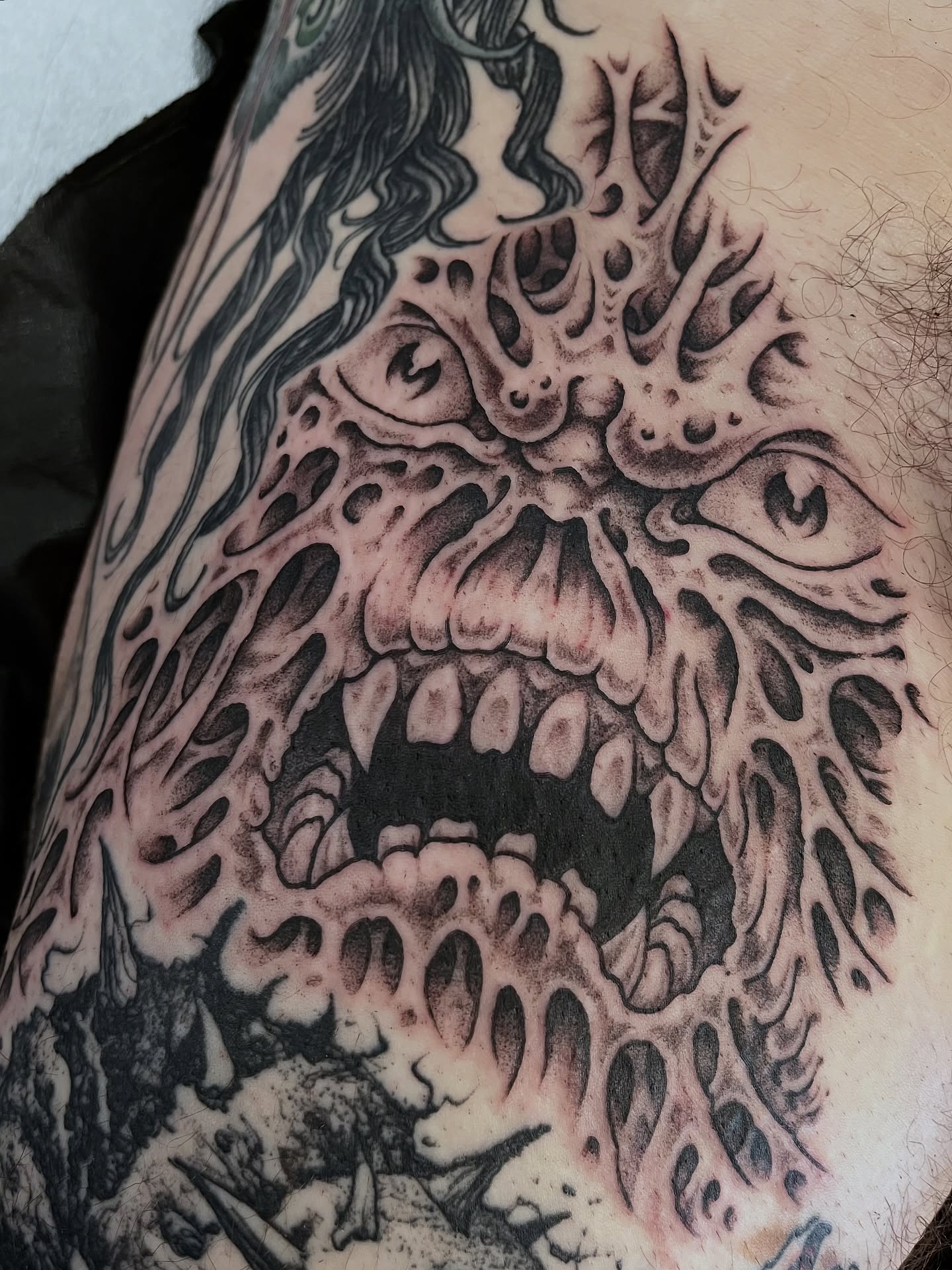Monster face realism tattoo on the thigh by Campbell Zane Alexander