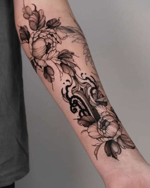 Peony flowers black and grey tattoo on the forearm by Anastasiia
