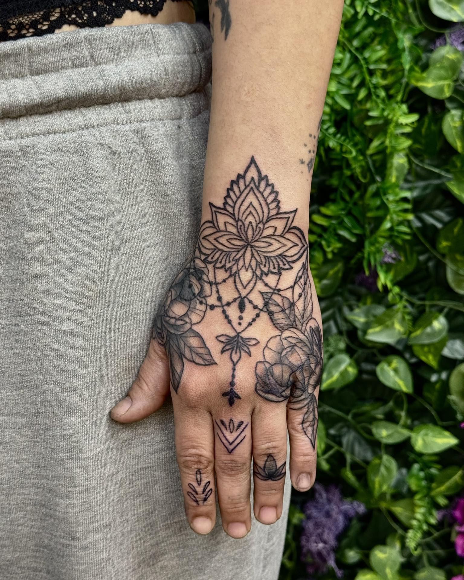 Lotus flower black and grey tattoo on the hand by Sabrina