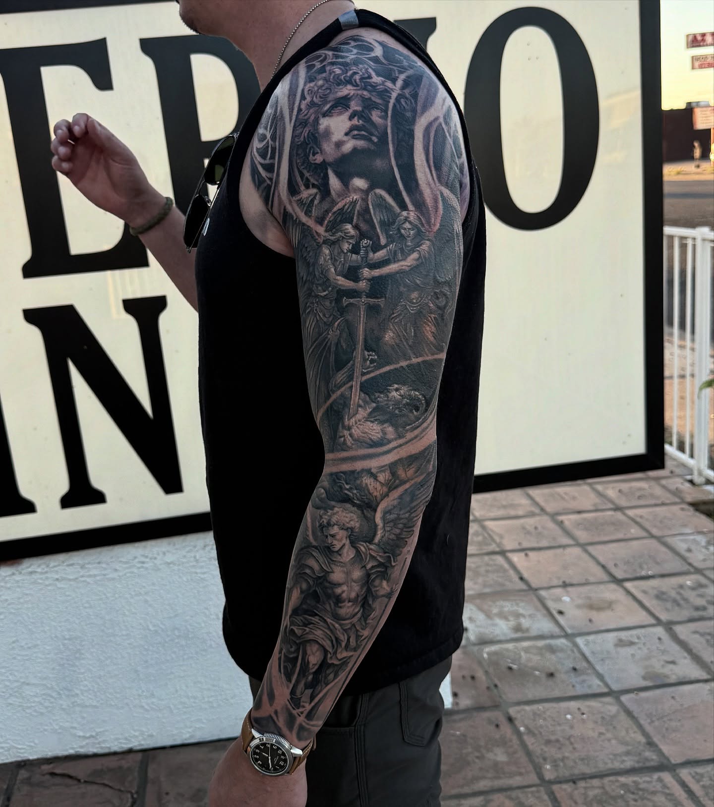 Religious scene realism tattoo on the upper arm by Alia