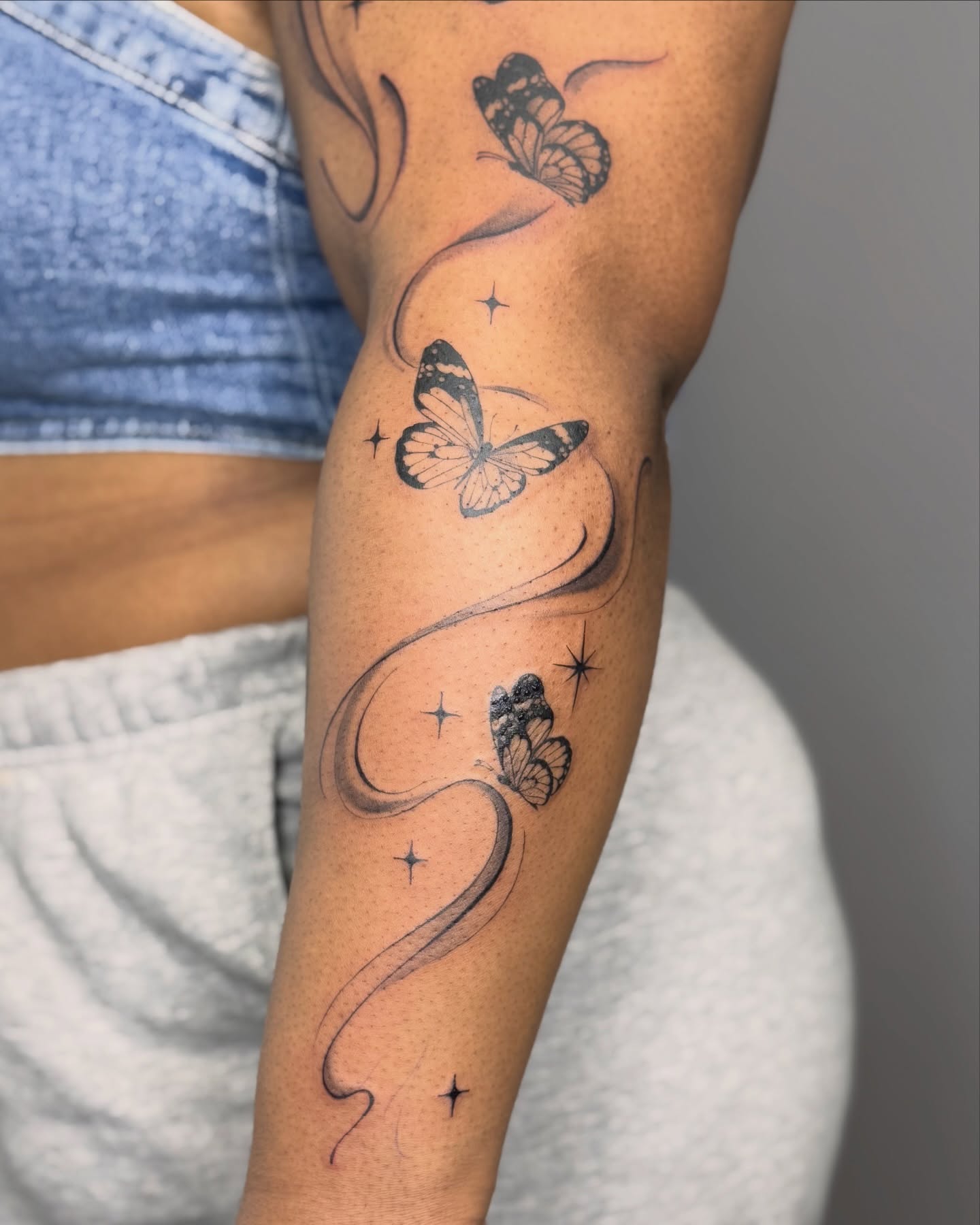 Butterflies black and grey tattoo on the forearm by Suzy