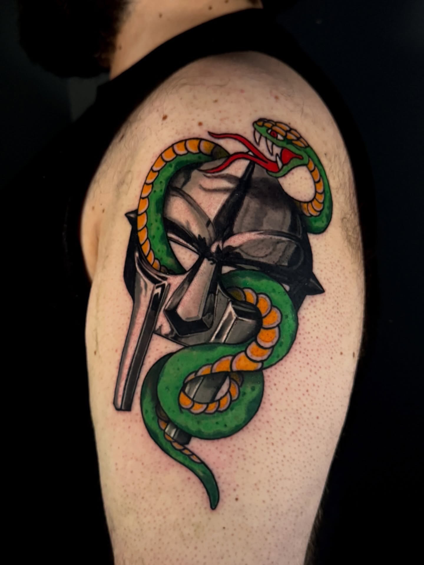 Snake and helmet American traditional tattoo on the shoulder by Dallas Tattoo Artist