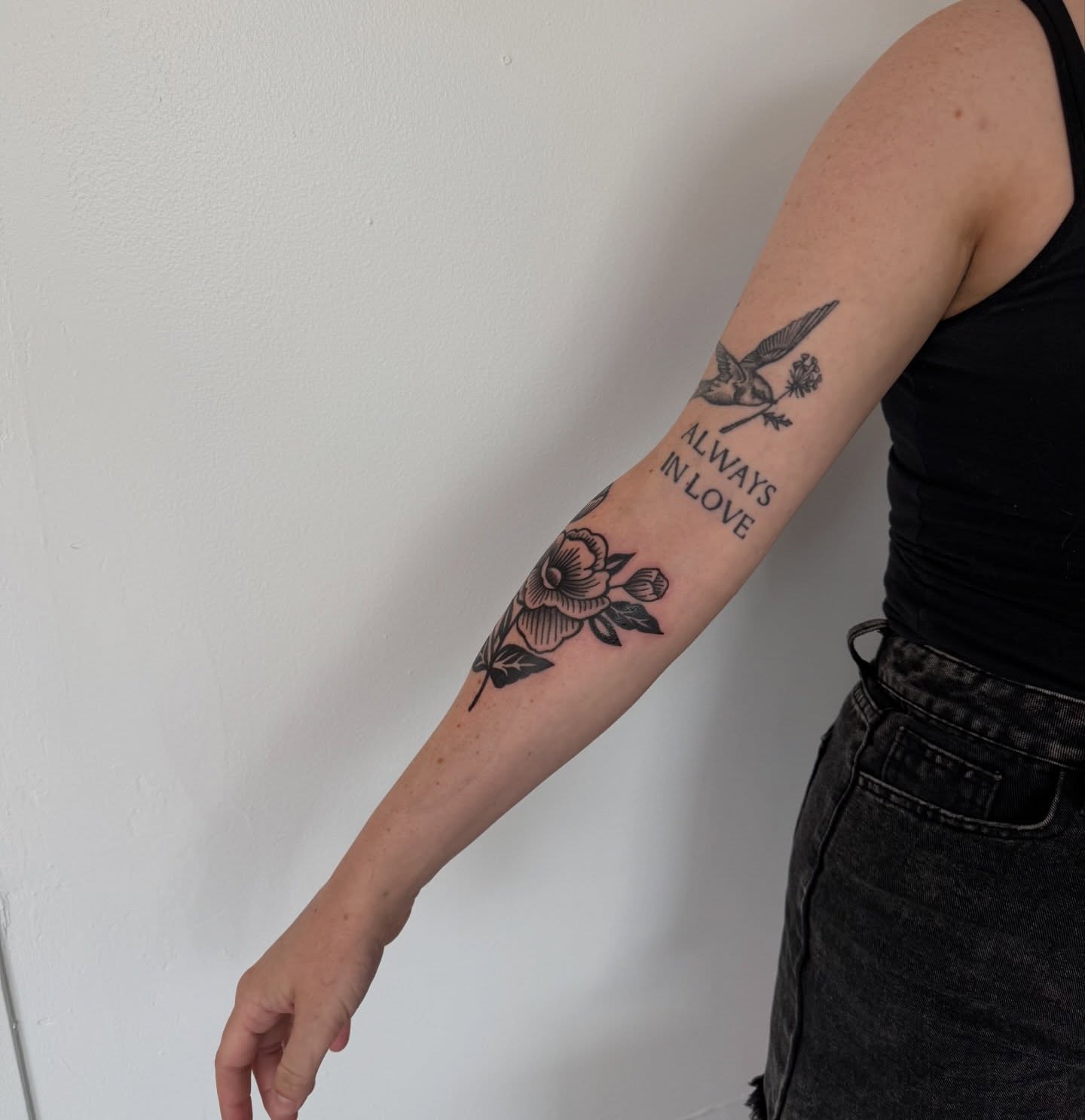 Flower and bird black and grey tattoo on the forearm by Lindsay Shriver
