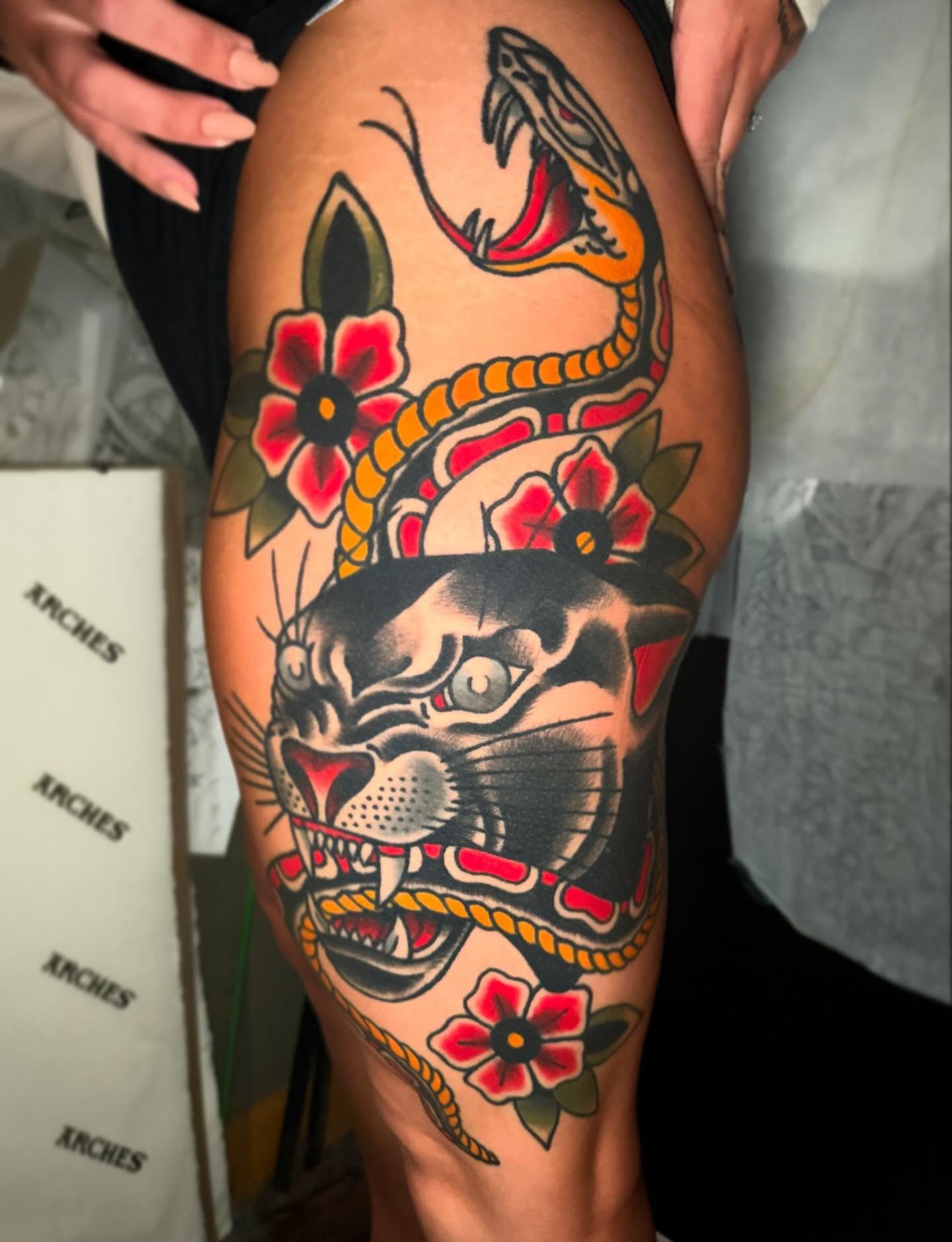 Panther and snake American traditional tattoo on the thigh by Mike Diamond