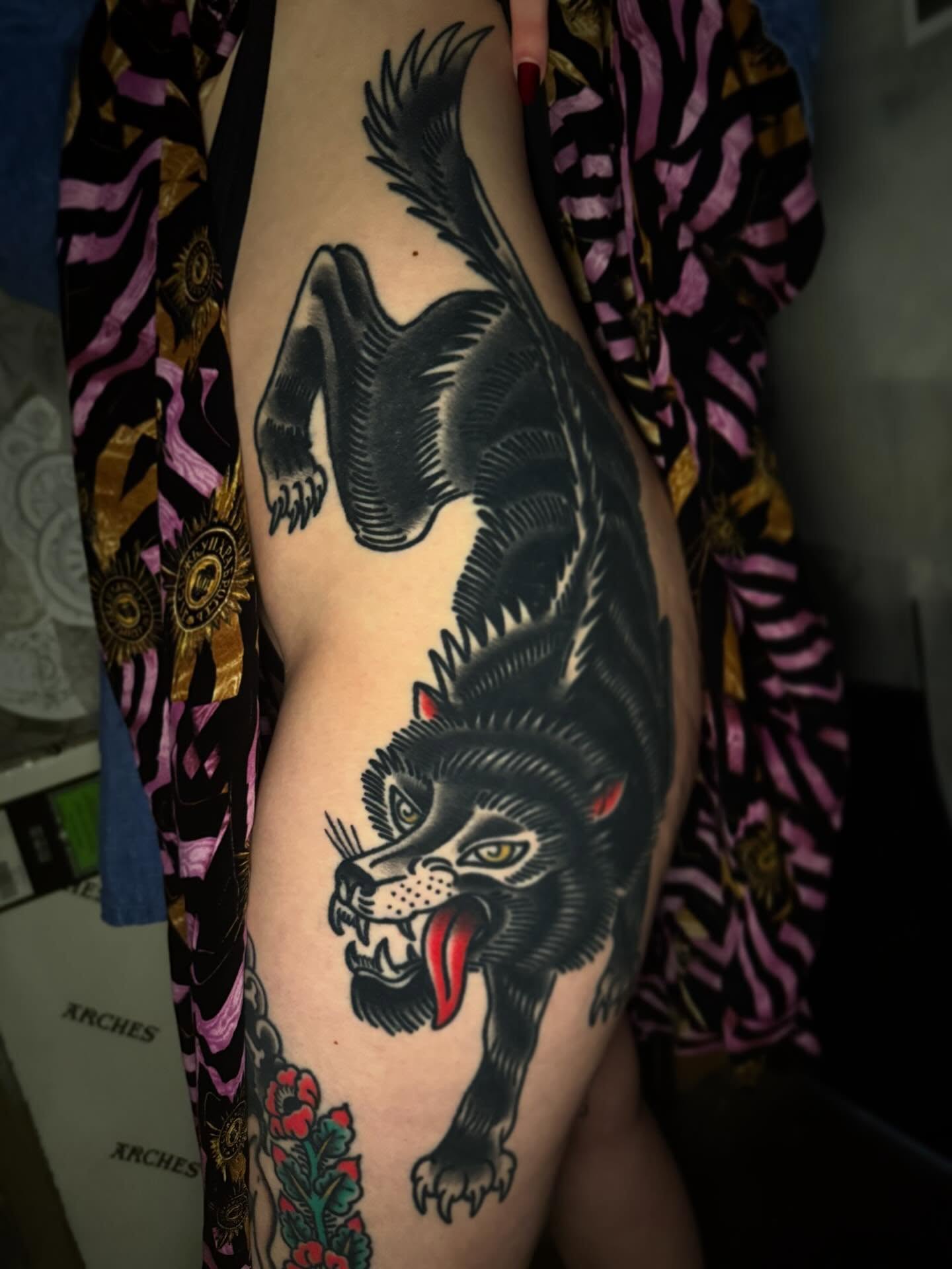 Wolf American traditional tattoo on the thigh by Mike Diamond