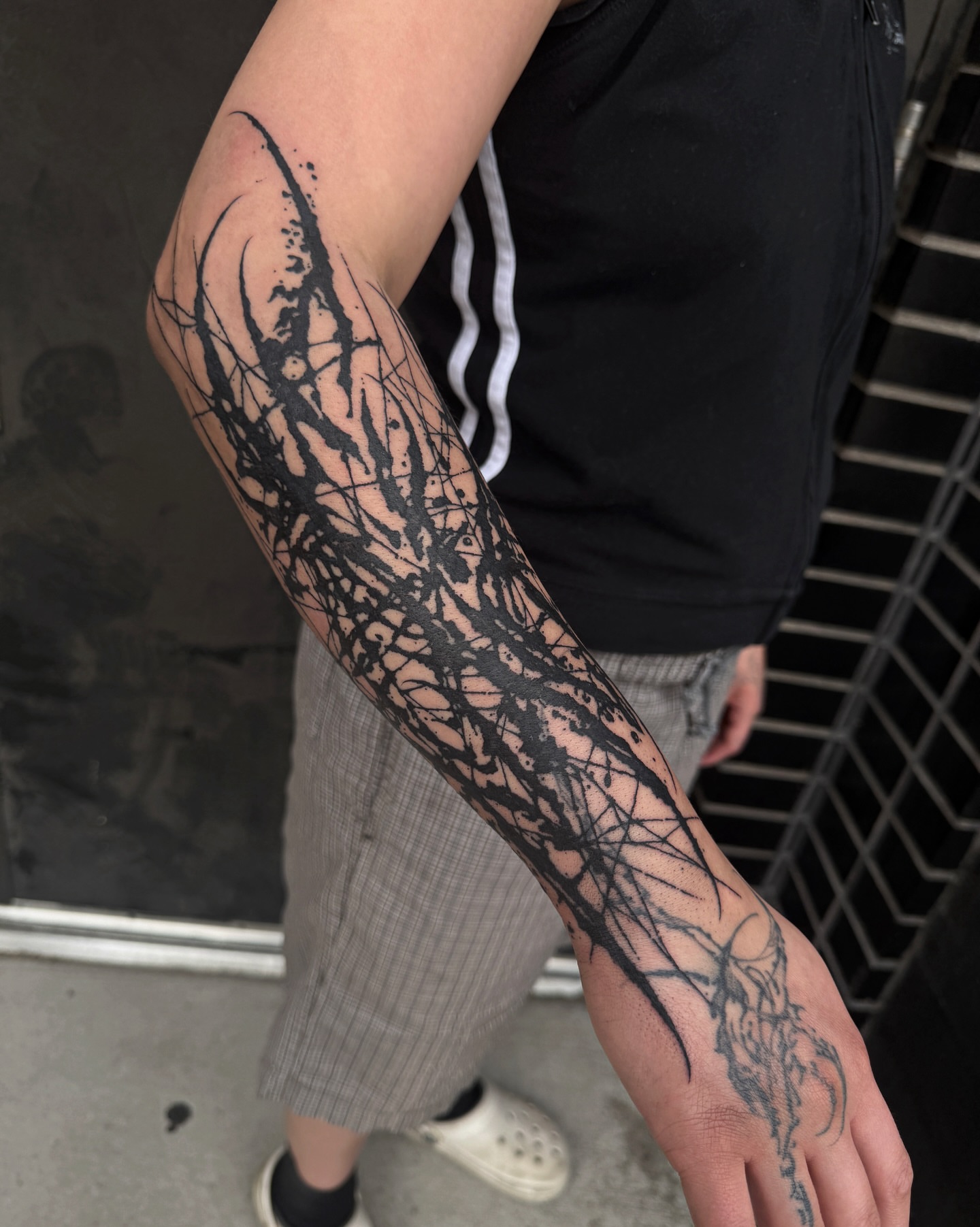 Abstract pattern black and grey tattoo on the forearm by Penelope