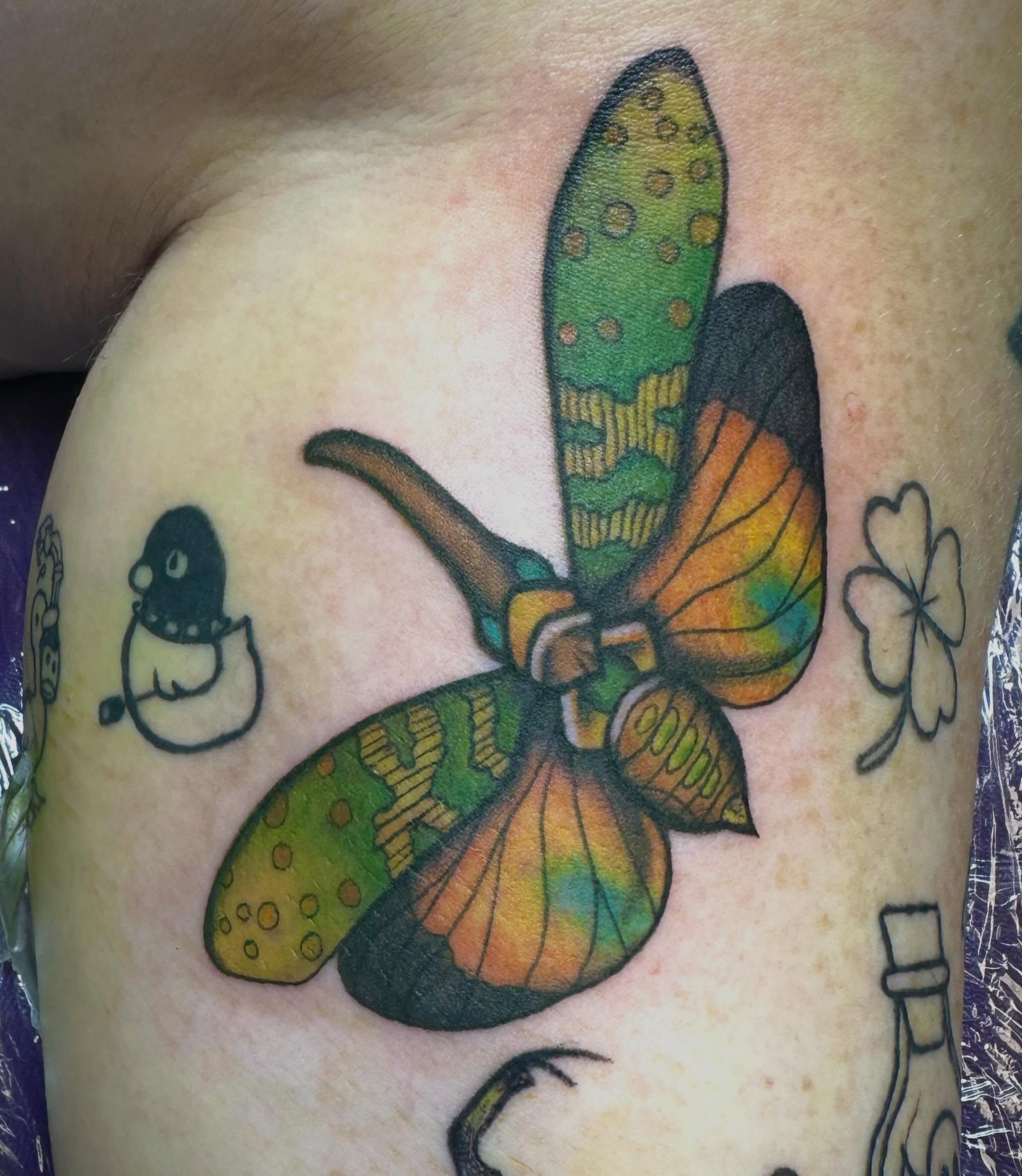 Butterfly American traditional tattoo on the shoulder by Mikaila Jean
