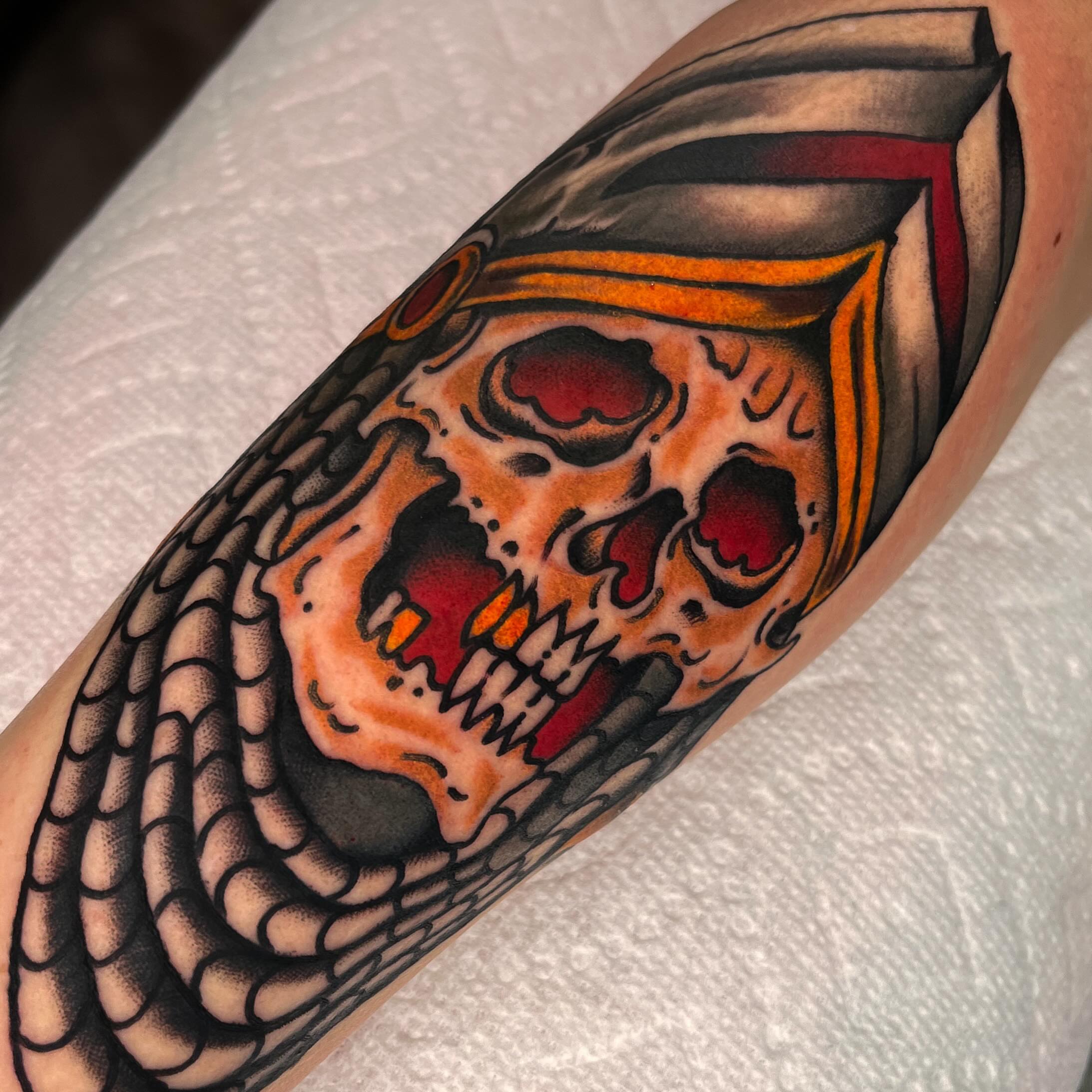Skull and book American traditional tattoo on the forearm by Sky G, Colorado Springs, Colorado