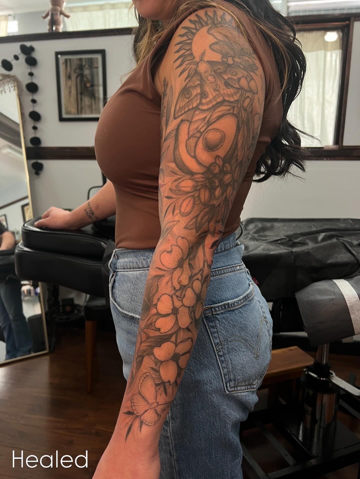 Floral sleeve black and grey tattoo on the upper arm by Avrey Simone