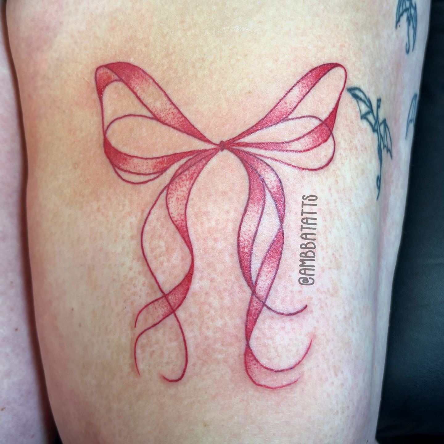 Bow dotwork tattoo on the thigh by amber brady, Brunswick, Ohio