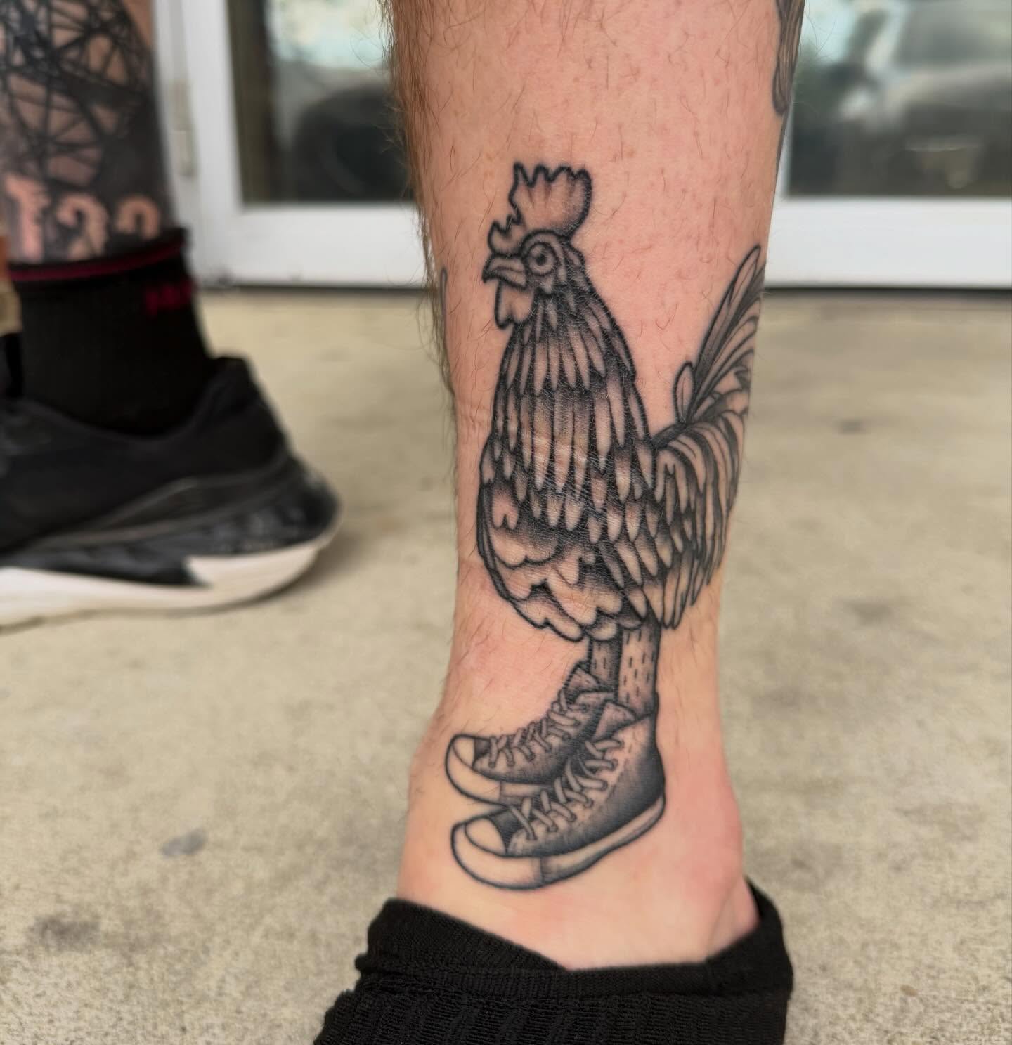 Rooster black and grey tattoo on the calf by rocky love
