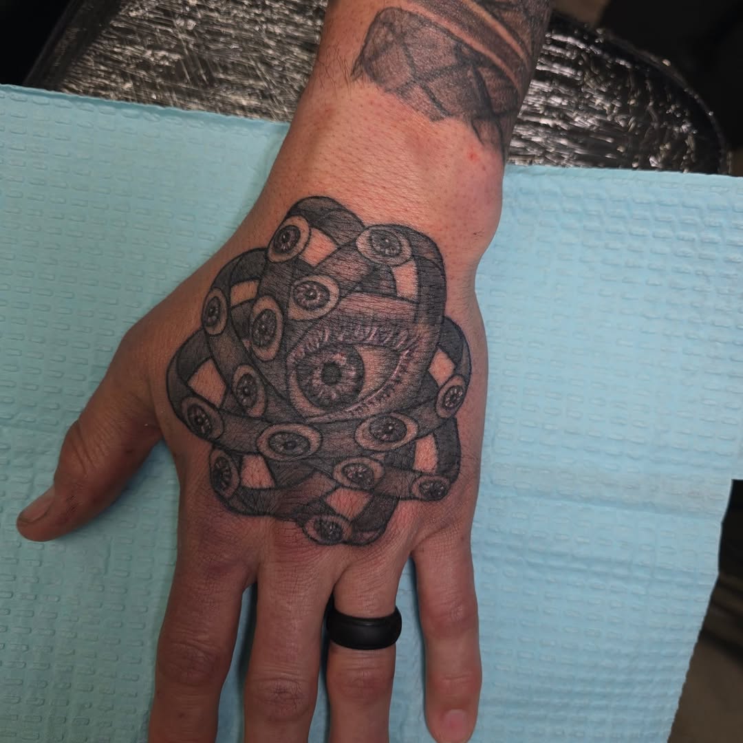 Abstract eye pattern geometric tattoo on the hand by Karen Cain