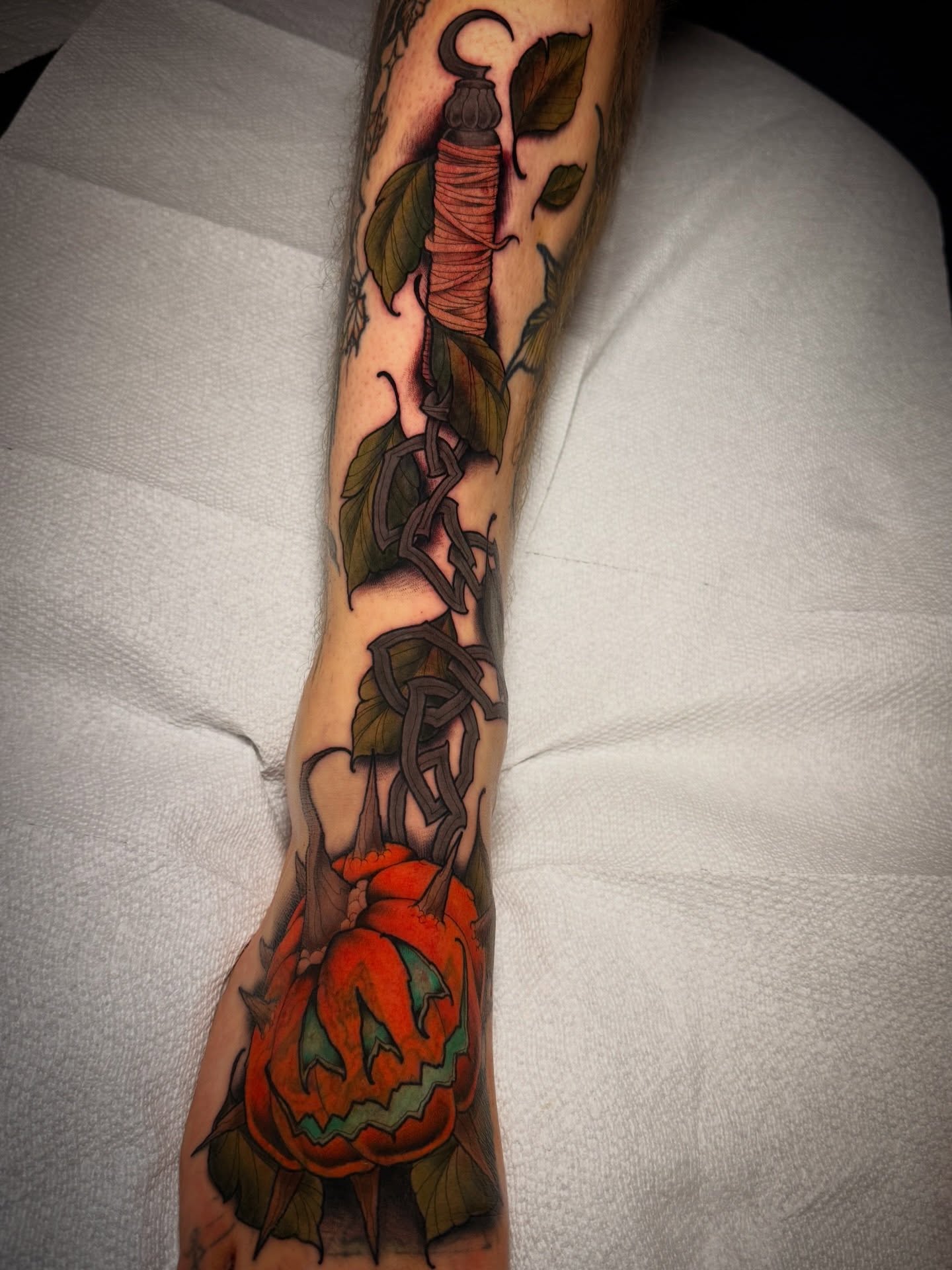Pumpkin and string American traditional tattoo on the forearm by Dave Osrowitz