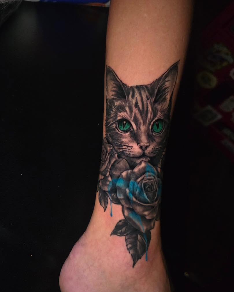 Cat with roses realism tattoo on the forearm by Tank Maass