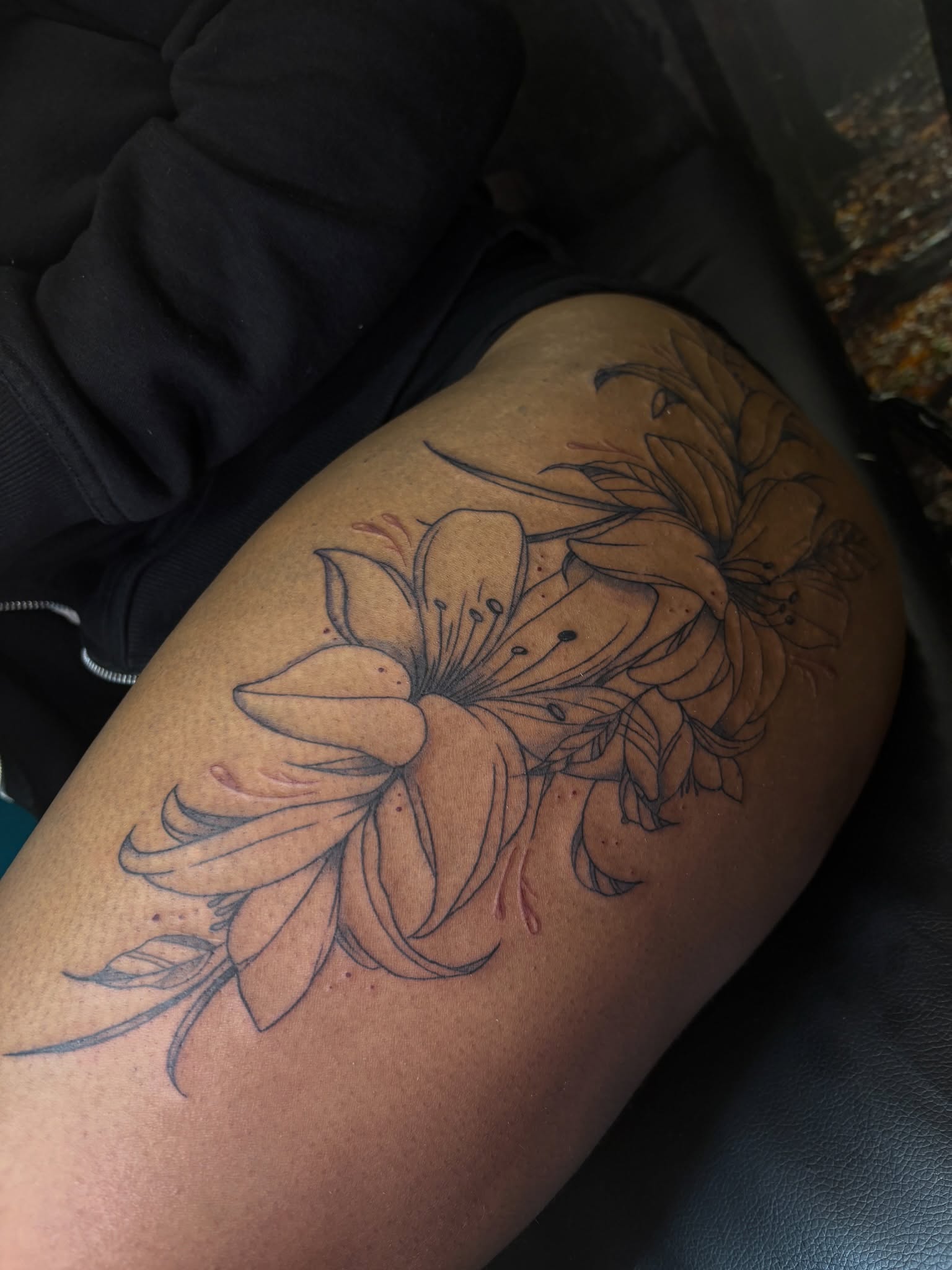 Lilies black and grey tattoo on the thigh by ⋆.˚ ☾ .⭒˚ alaina