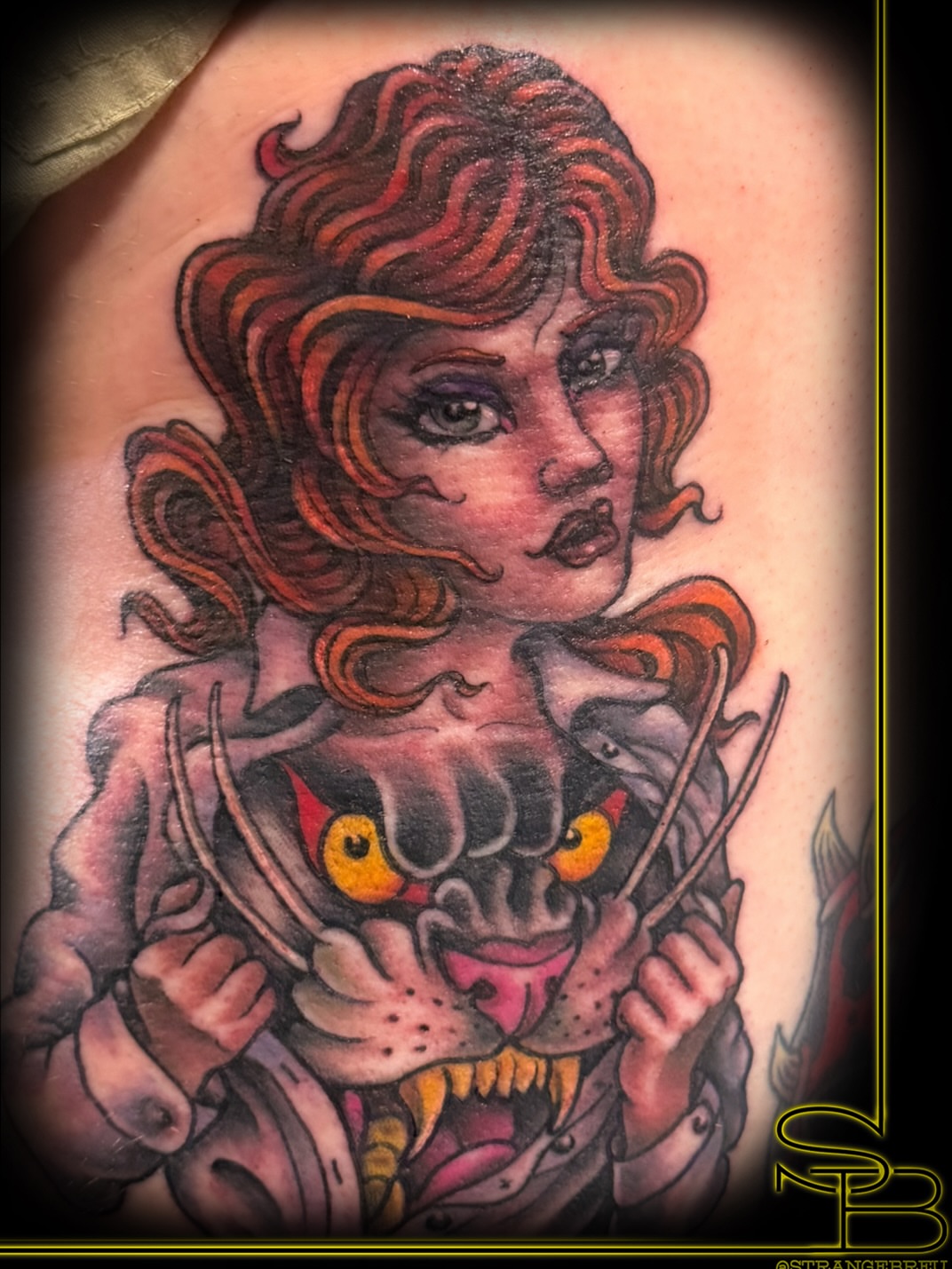 Woman with lion American traditional tattoo on the shoulder by Chris Breuer, Asbury Park, New Jersey
