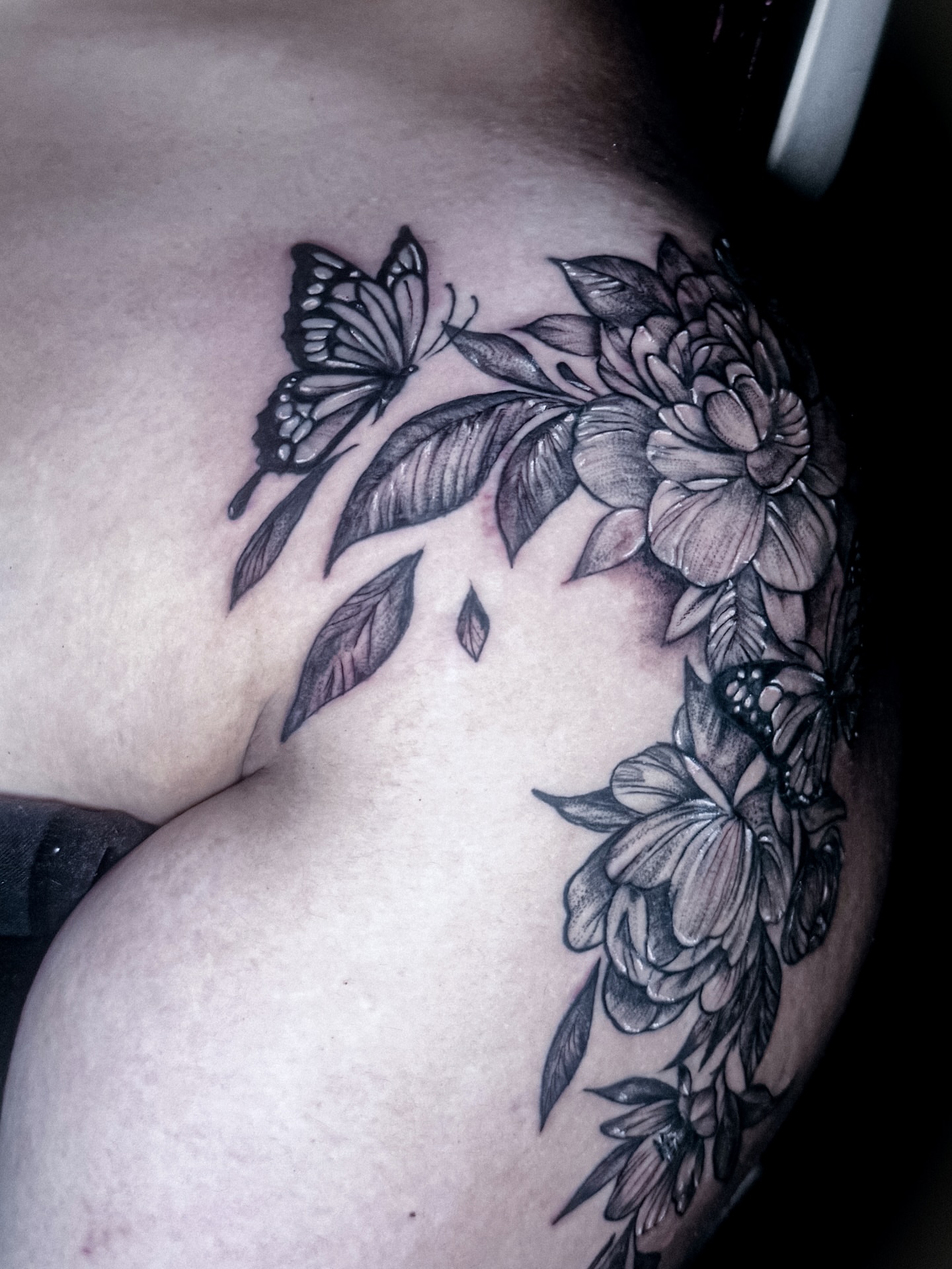 Butterfly and flowers realism tattoo on the shoulder by Ken West