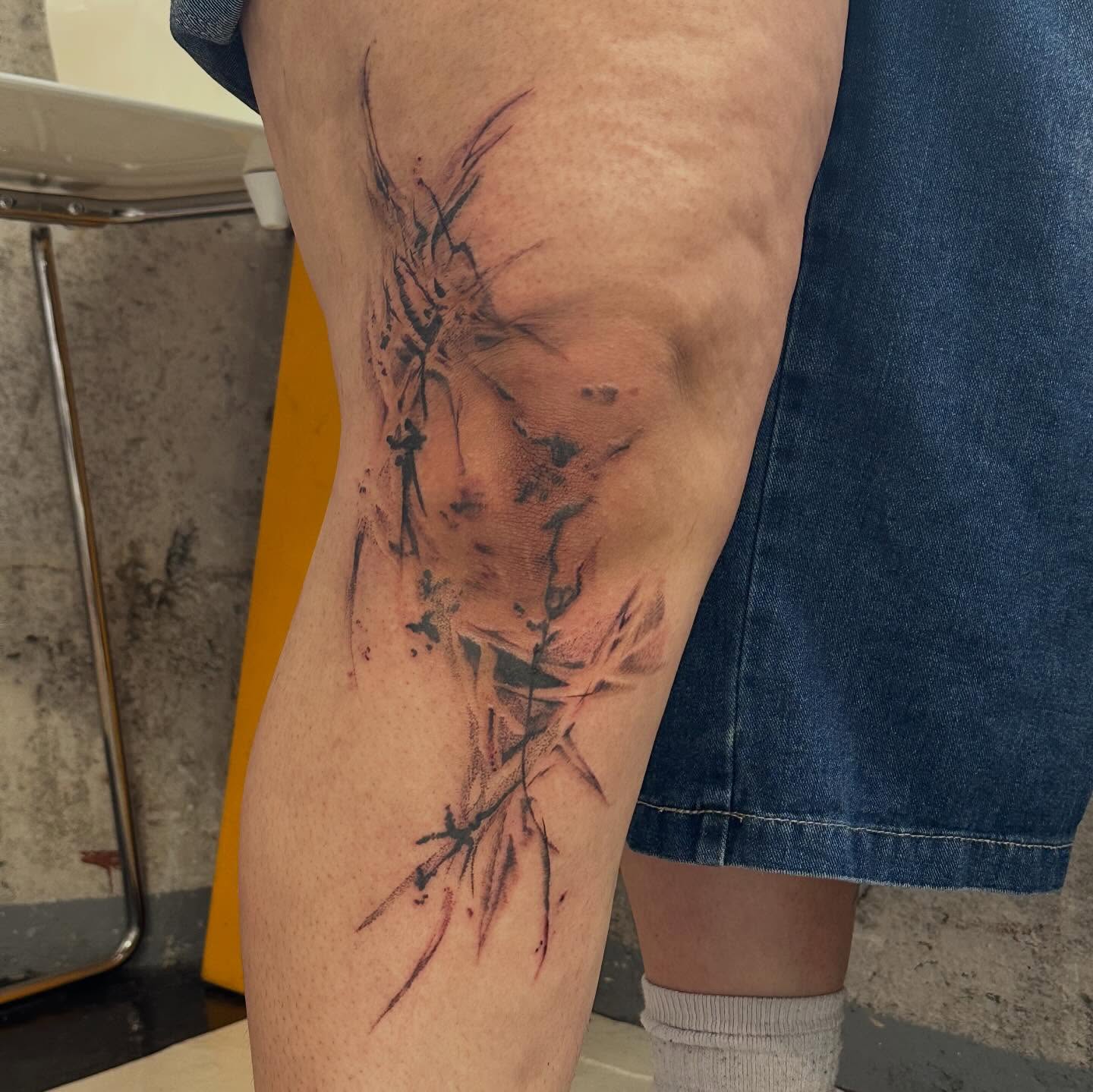 Abstract plant watercolor tattoo on the thigh by Jules🕯️