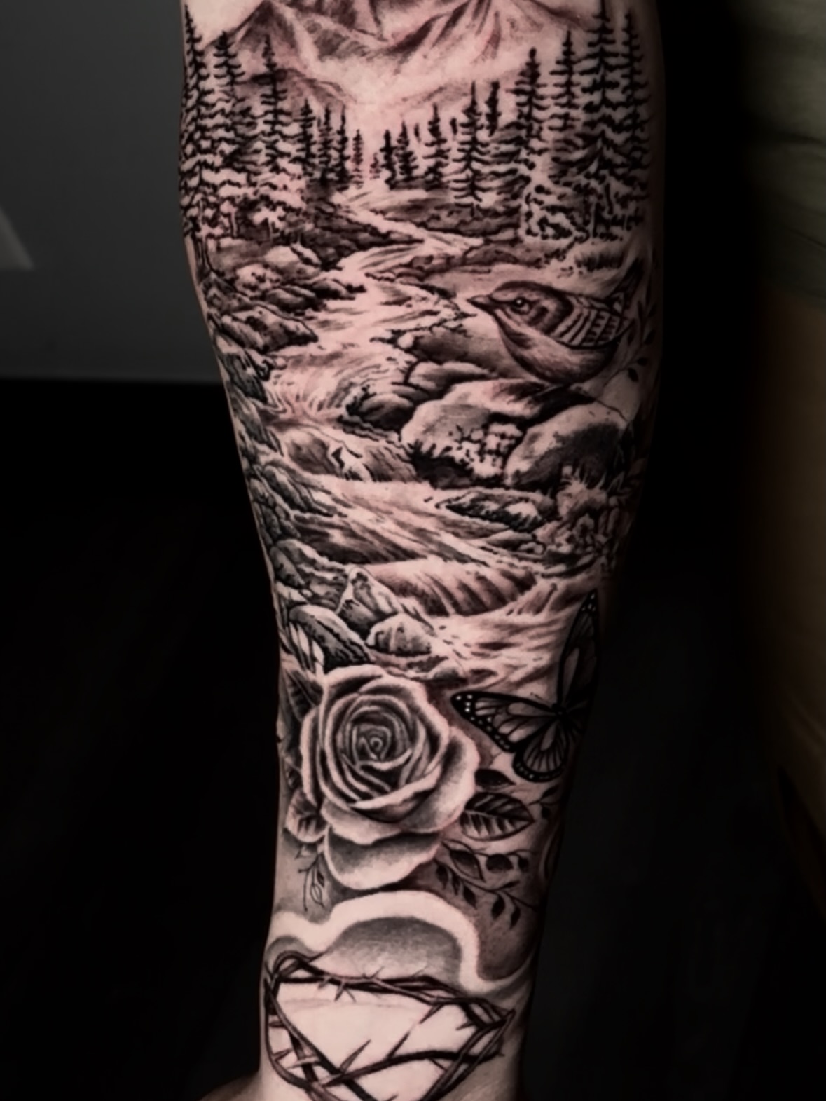 Forest landscape realism tattoo on the forearm by Dave