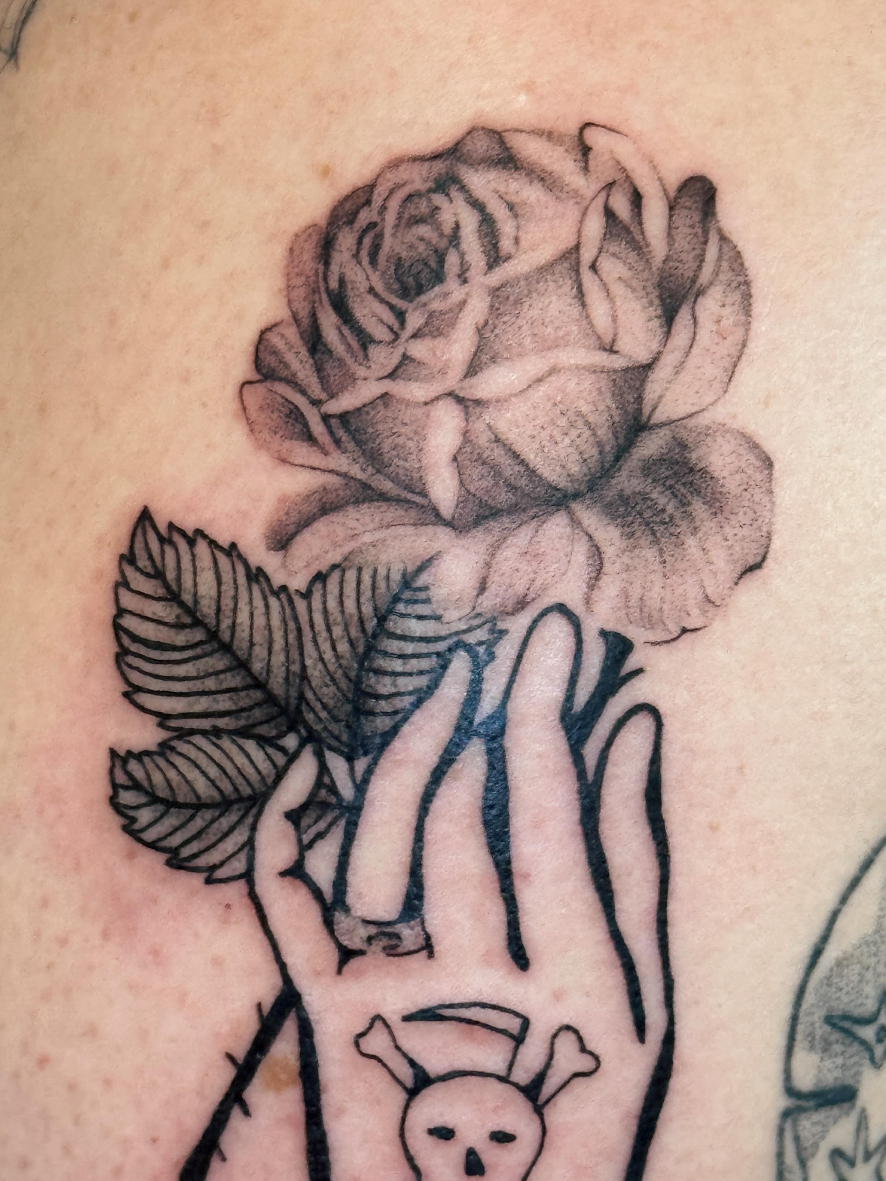 Rose and hand black and grey tattoo on the hand by tattoos by miss jackie o 🎱