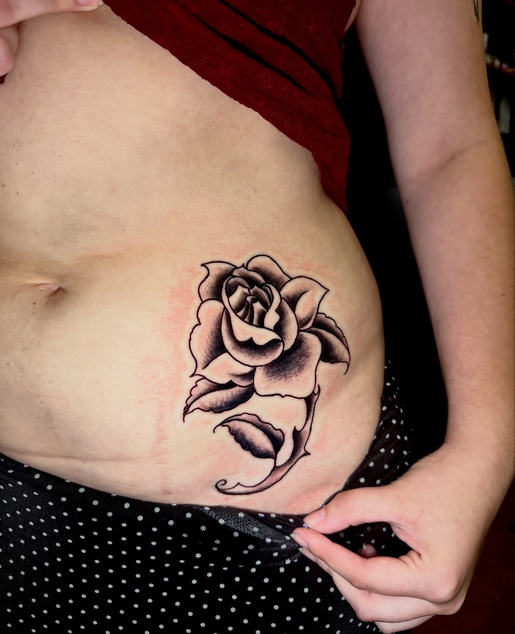 Rose black and grey tattoo on the torso by Noah Vincent Tattoo, Vancouver, Washington