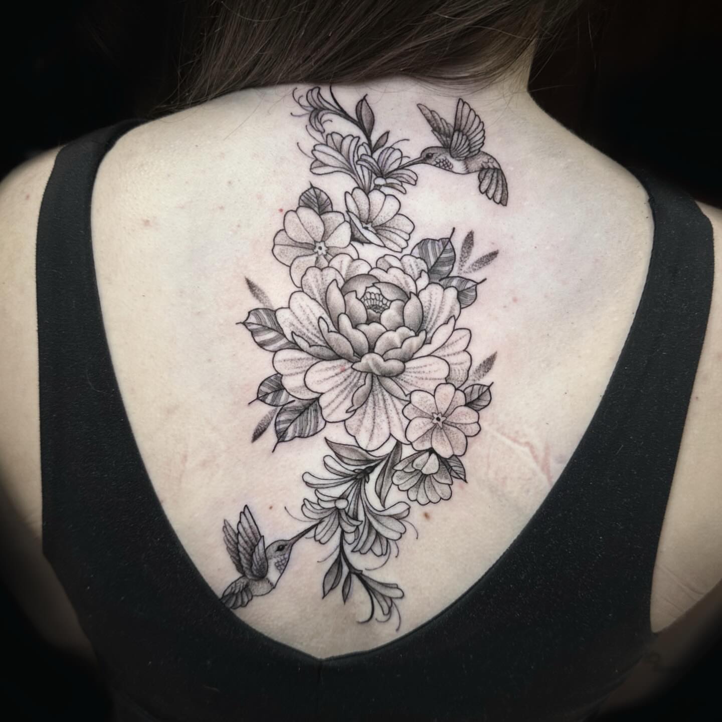 Floral bouquet with birds realism tattoo on the back by Kelsea Weir McCree