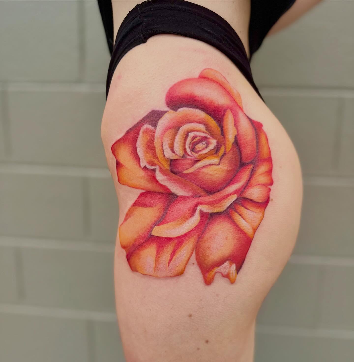 Rose realism tattoo on the thigh by Cohen