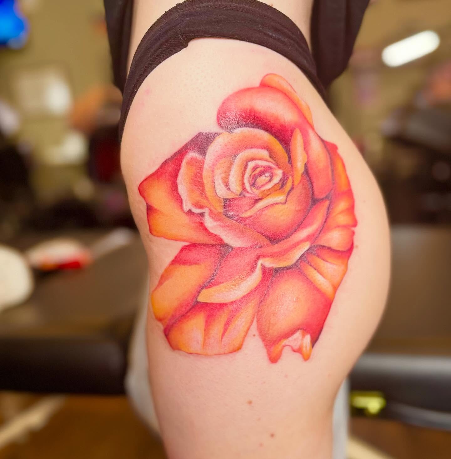 Rose realism tattoo on the thigh by Cohen