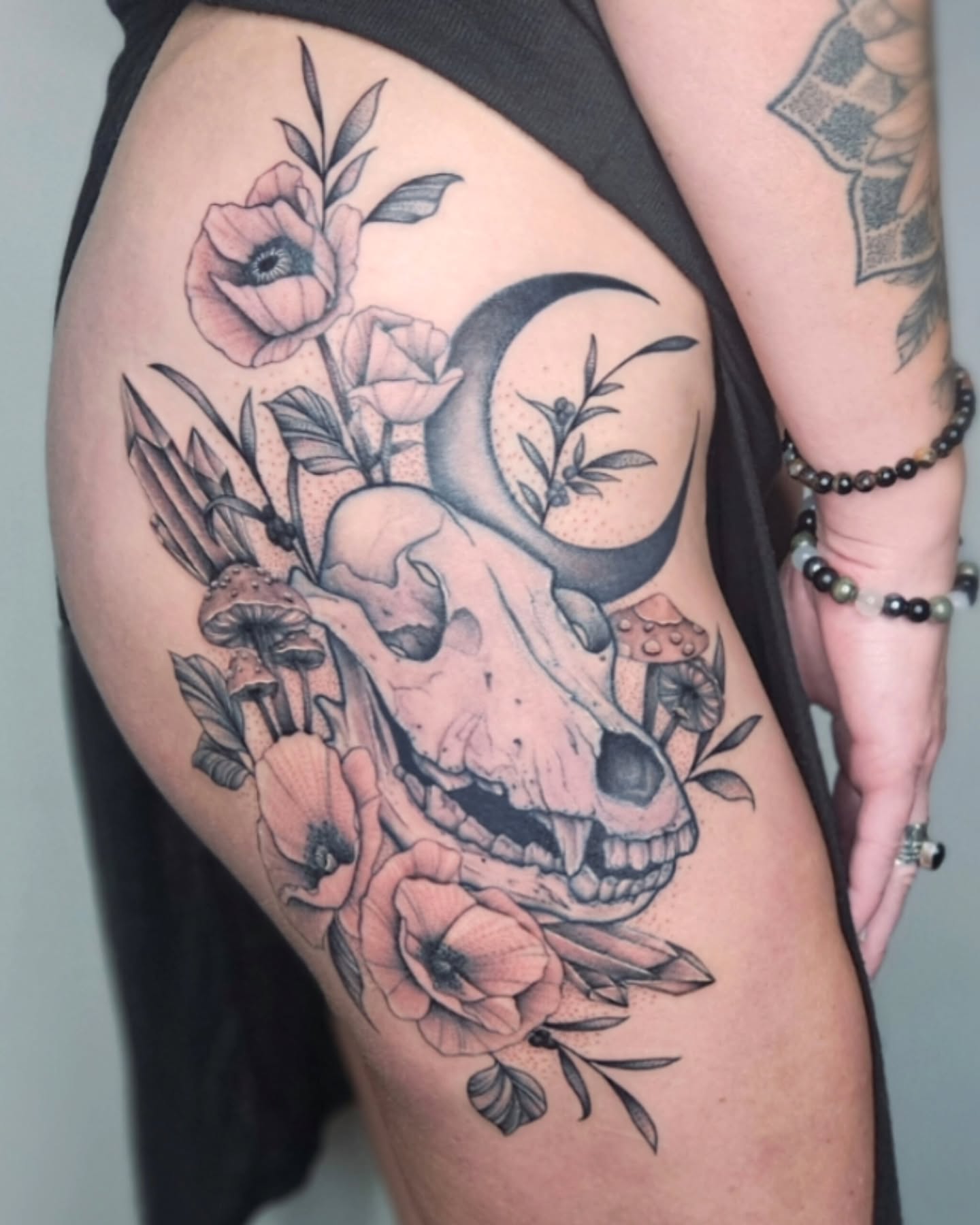 Skull and flowers realism tattoo on the thigh by TaylorLeighShermanTattoos OFFICIAL