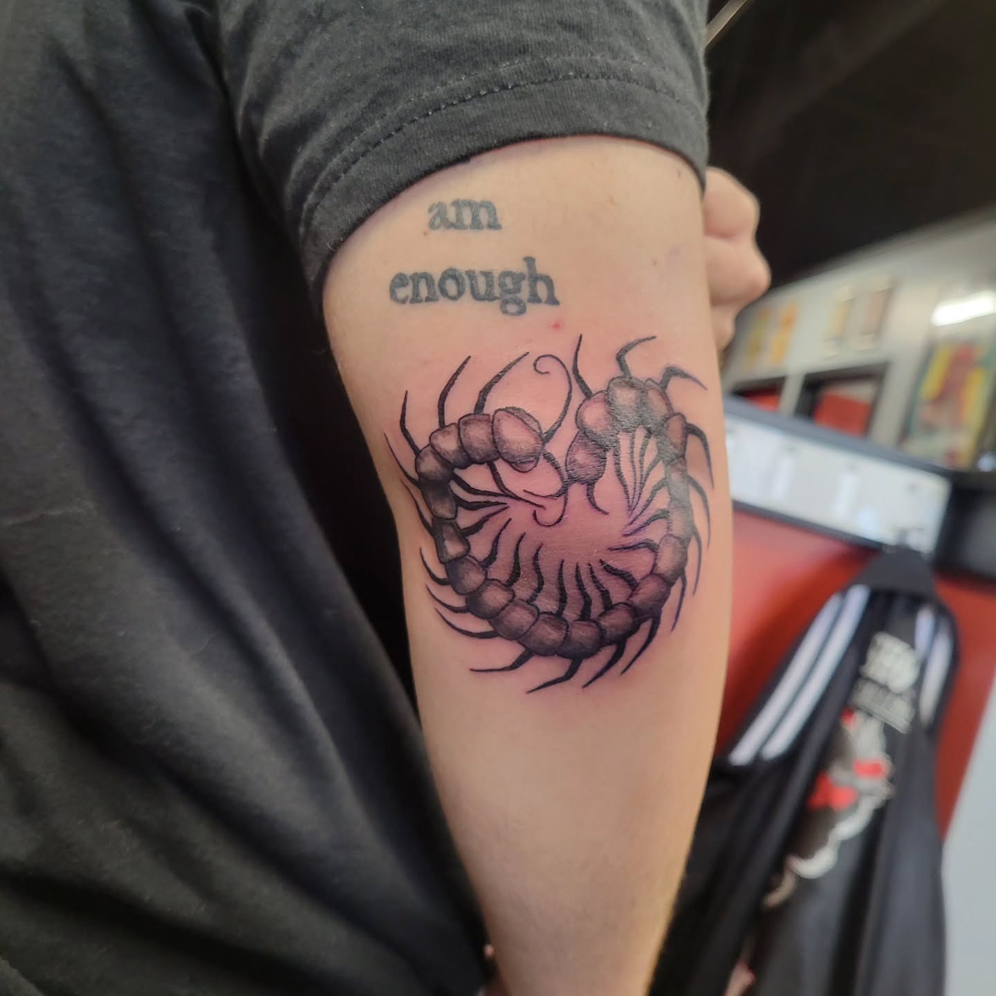 Centipede black and grey tattoo on the forearm by Aspen C