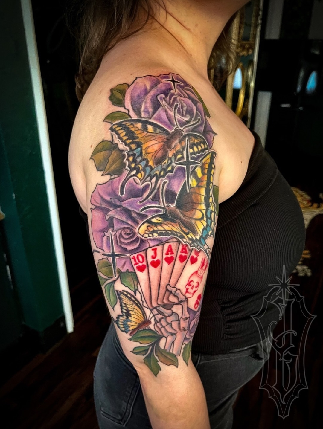 Roses and butterflies American traditional tattoo on the upper arm by Jessica Burridge