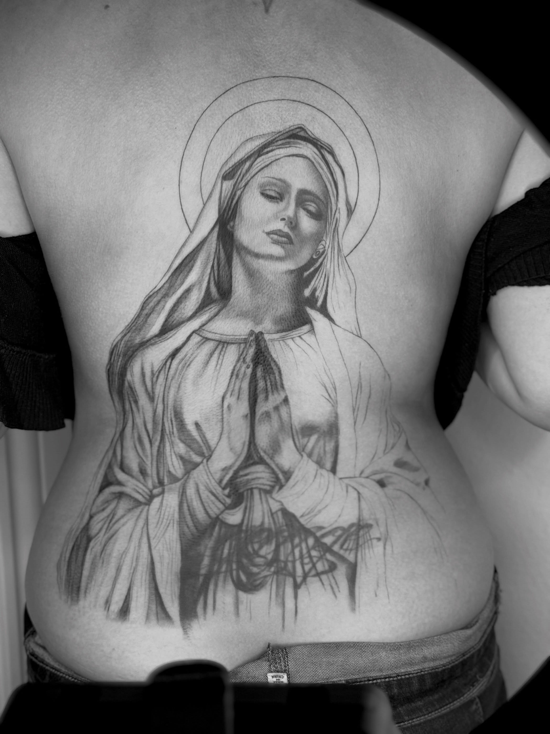 Praying woman realism tattoo on the back by Ashley Limon